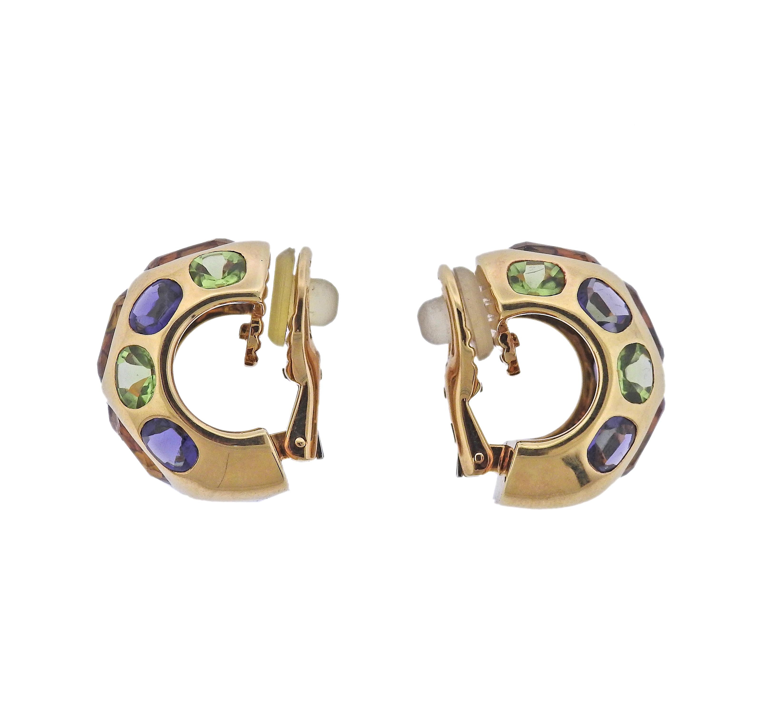Pair of 18k gold half hoop Coco earrings by Chanel, set with citrines, peridots and iolite gemstones.  Earrings measure 21mm x 15mm. Weight - 22.7 grams. Marked: Chanel, 750, 1D6704.