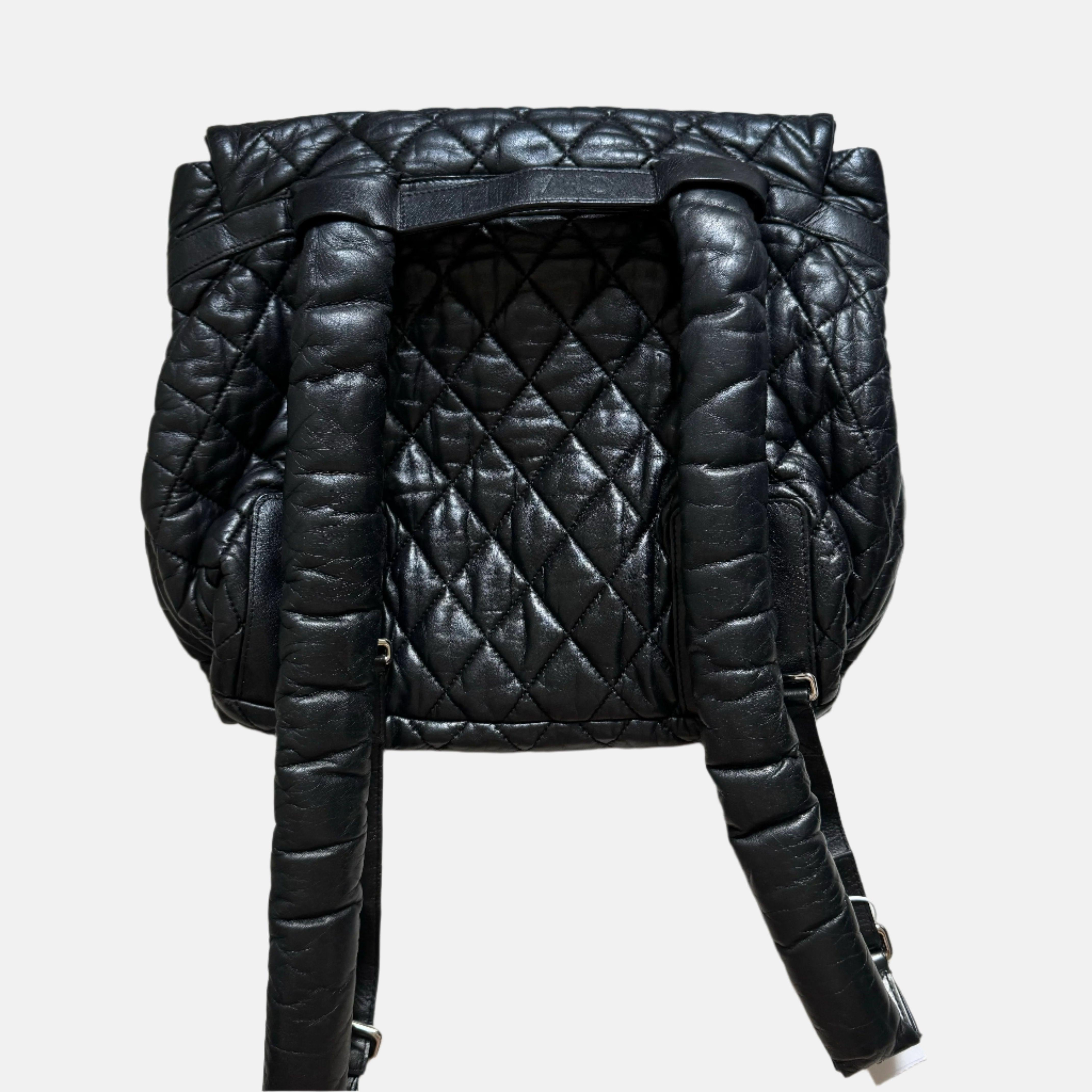 Chanel Coco Cocoon Flap Backpack Lambskin Leather Diamond Quilted Black, 2009-2010
 These are professional photos of the actual bag.
 CONDITION: VERY GOOD 
 Light creases on the bottom and light scratches on the back of the bag. Light scratches to