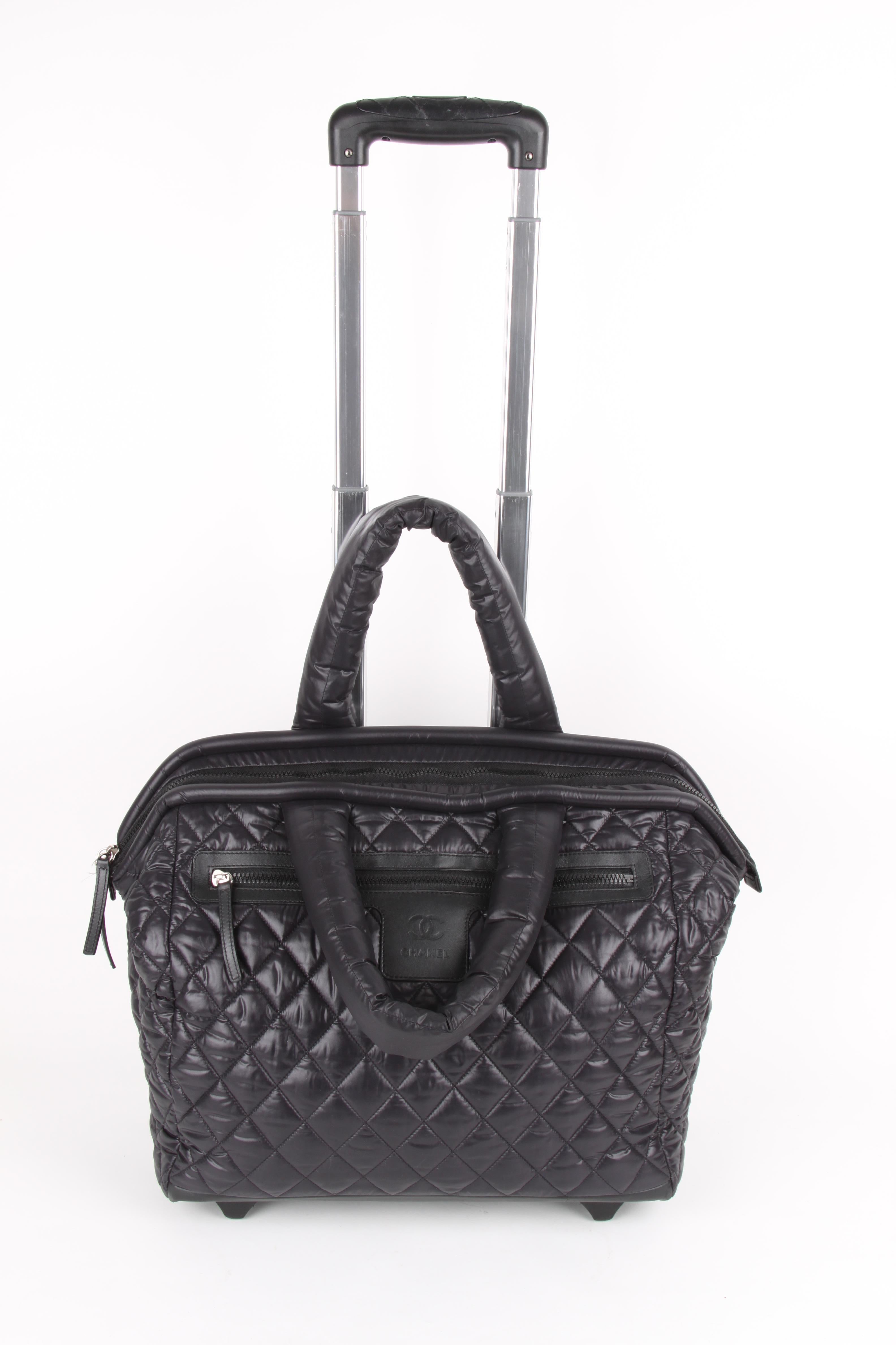 The Chanel Black Quilted Nylon Coco Cocoon Trolley Rolling Case is a highly sought after piece from Lagerfeld's fun and chic Coco Cocoon line.

Leather trim zipper details feature the Chanel logo and the easy-to-open plastic zipper opens to reveal a
