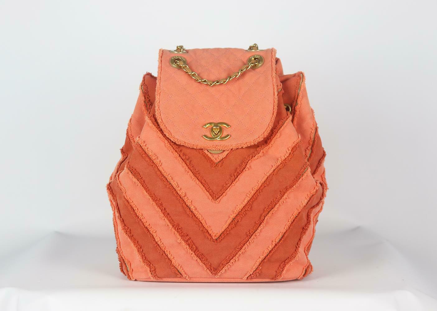 Made in Italy, this beautiful Chanel Coco Cuba Chevron backpack has been made from orange canvas and beige leather exterior with grey fabric interior, this piece is decorated with Chanel's logo in antiqued-gold on the front and finished with chain