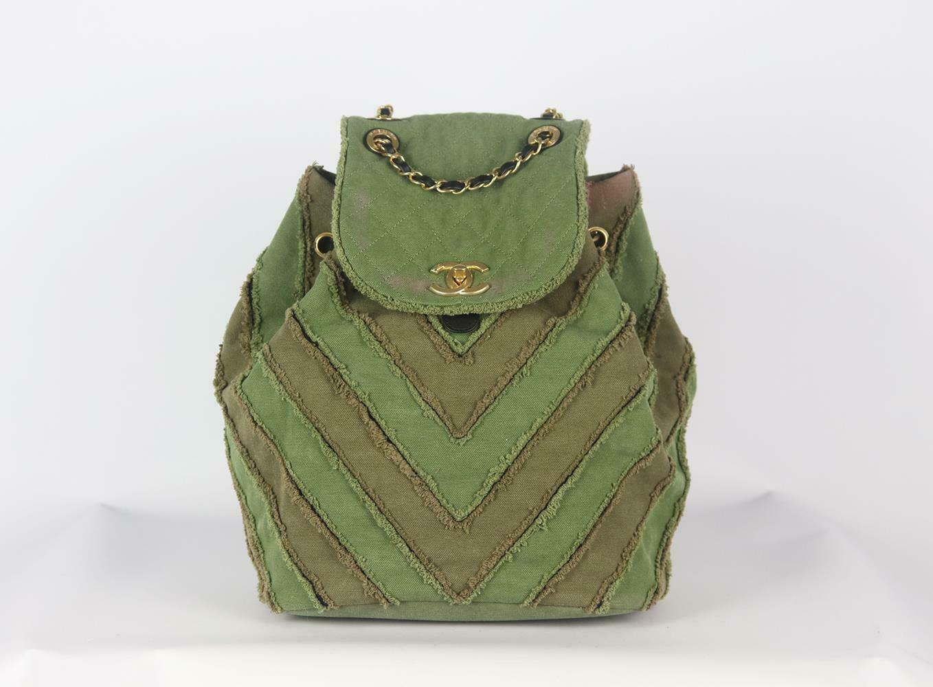 Made in Italy, this beautiful Chanel Coco Cuba Chevron backpack has been made from khaki canvas and black leather exterior with pink fabric interior, this piece is decorated with Chanel's logo in antiqued-gold on the front and finished with chain