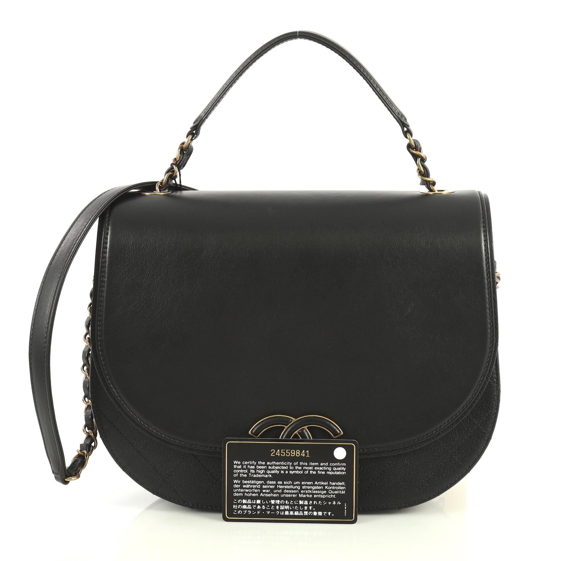This Chanel Coco Curve Flap Messenger Calfskin and Quilted Goatskin Medium, crafted in black calfskin and quilted goatskin, features woven-in leather chain strap with leather pad, exterior back zip pocket, and brass-tone hardware. Its CC snap