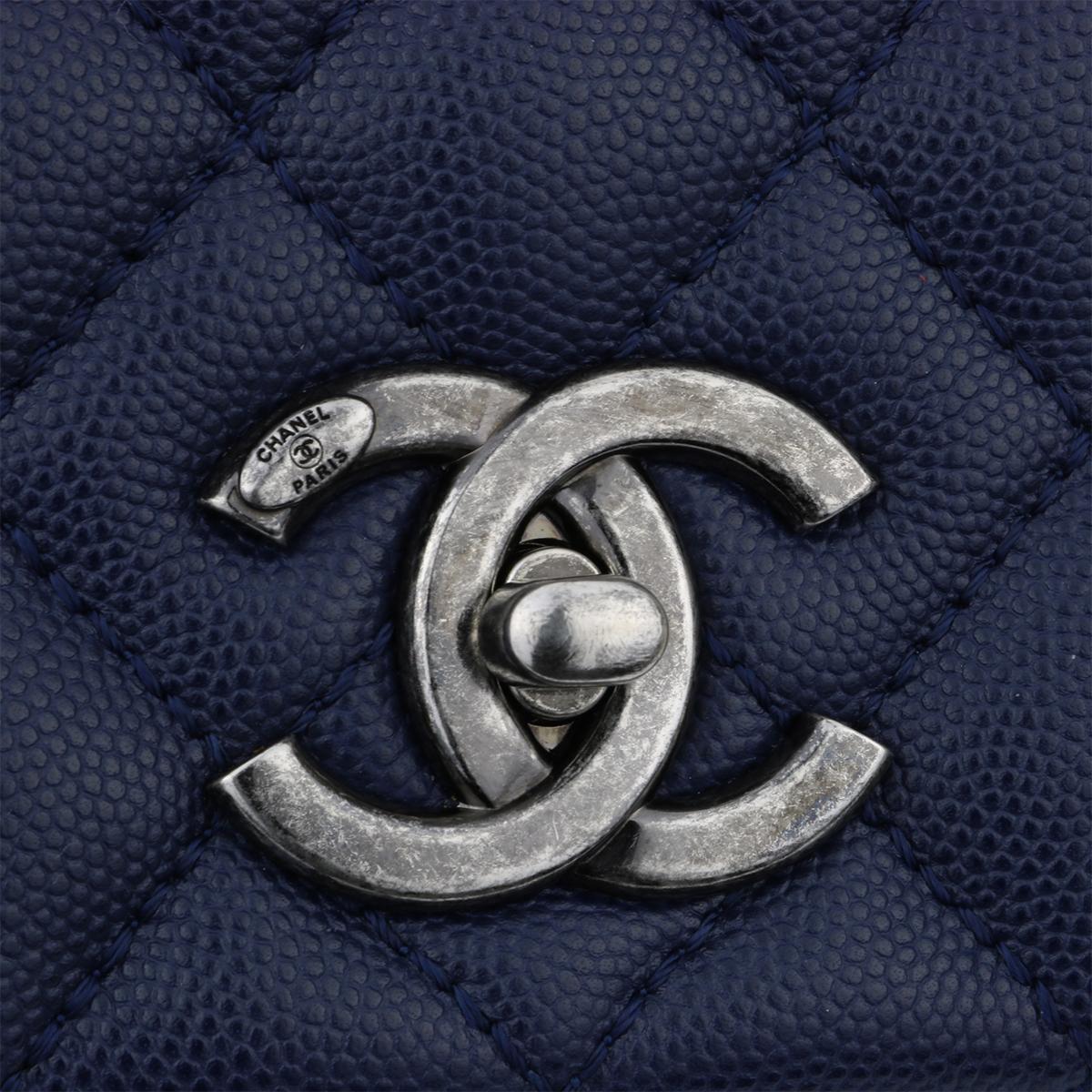 Authentic CHANEL Coco Handle Bag Large Navy Caviar with Ruthenium Hardware 2017.

This bag is in mint condition, the bag still holds its shape well, and the hardware is still shiny.

Exterior Condition: Mint condition, corners show no visible signs