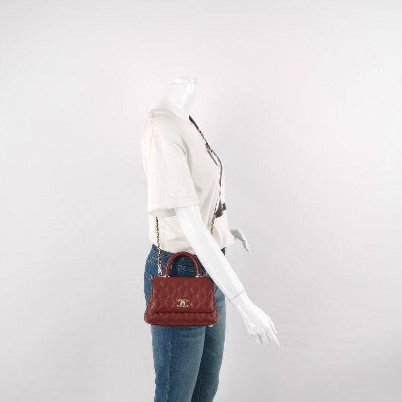 Chanel Coco Handle Mini Burgundy Caviar Leather Crossbody Bag
 These are professional photos of the actual bag.
 Crafted from soft lambskin leather, the CHANEL Paris-Rome Cross Stitch Mini Coco Handle Red Crossbody Bag exudes timeless elegance in a
