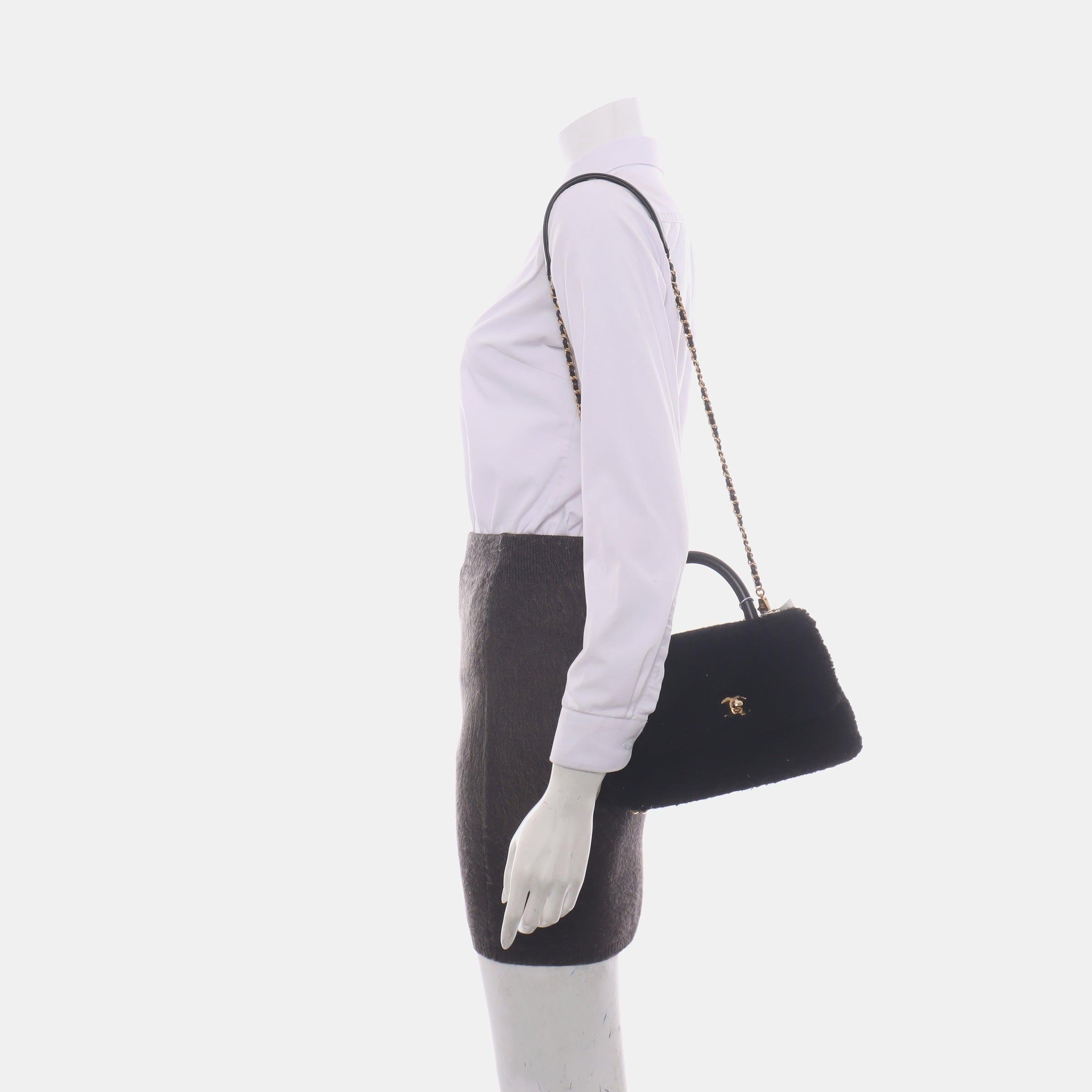 Chanel Coco Handle Small Black Shearling Gold Hardware, 2017
 These are professional photos of the actual bag offered by Luxbags.
 CONDITION: VERY GOOD
 Light rubbing around the corners, strap, flap and scratches to the hardware. Light stains on the