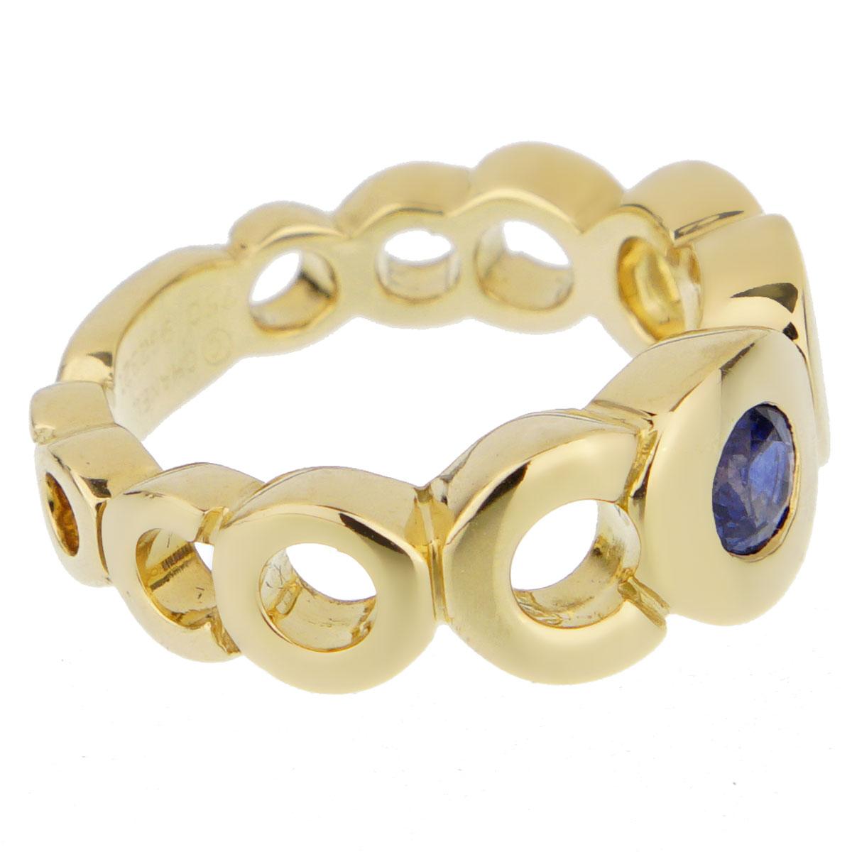 A fabulous Chanel openwork Coco ring set with a .30ct appx sapphire in shimmering 18k yellow gold. The ring measures a size 5 and can be resized.