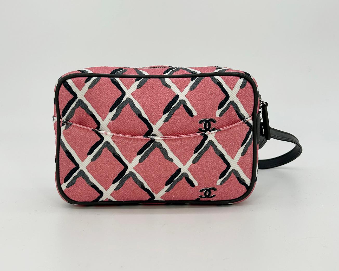 Chanel Coco Pink Canvas Beach Pouch Wristlet in like new condition. Pink printed canvas exterior with black gray and white crosshatch print throughout. Gray leather piping trim and silver hardware. Gray leather wrist strap. Backside exterior slit