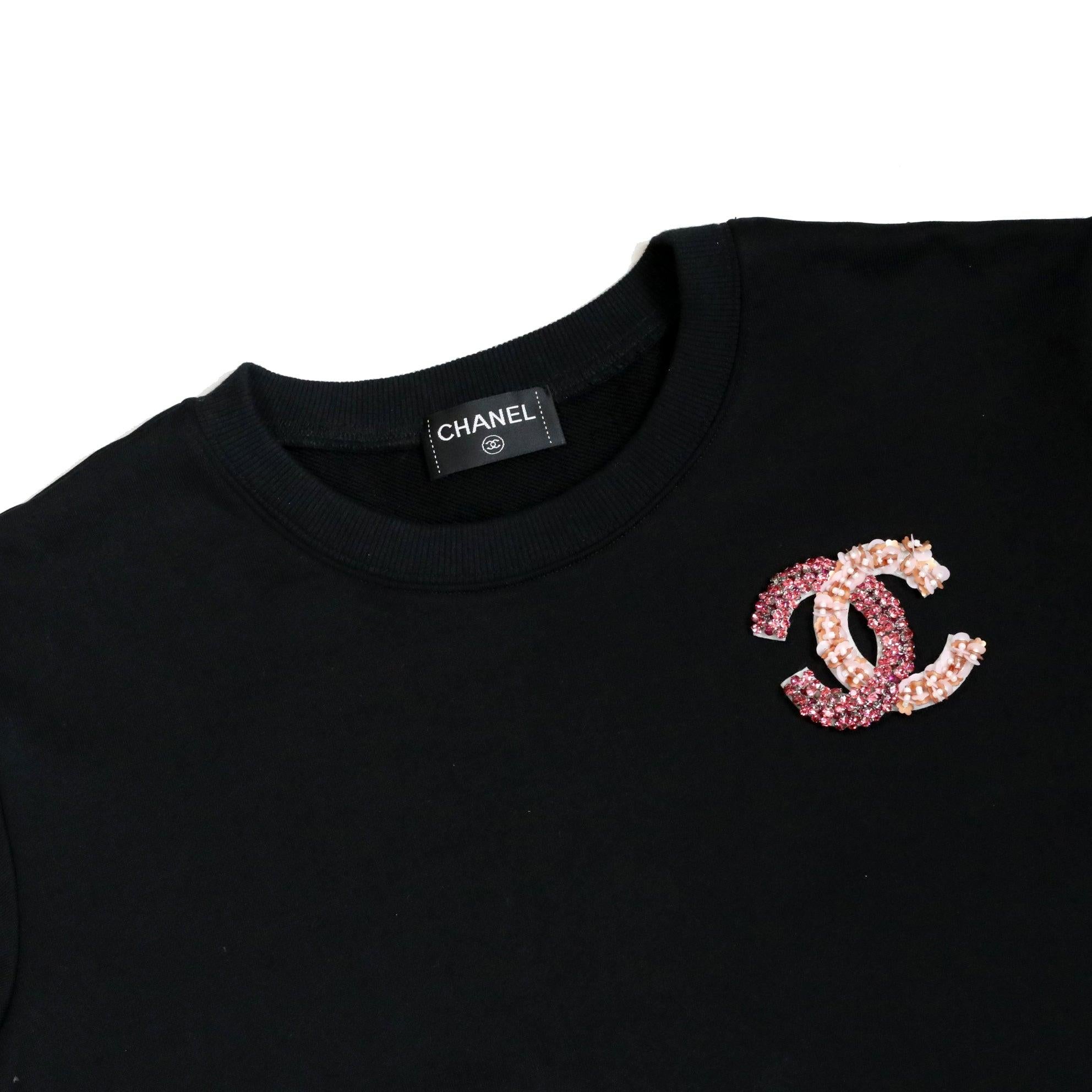 You will make a bold and stylish statement when you wear this Chanel sweater.

This Chanel sweater is made with luxurious black premium soft cotton and features exquisite embroidered diamond and crystal lurex flowers to showcase the signature CC