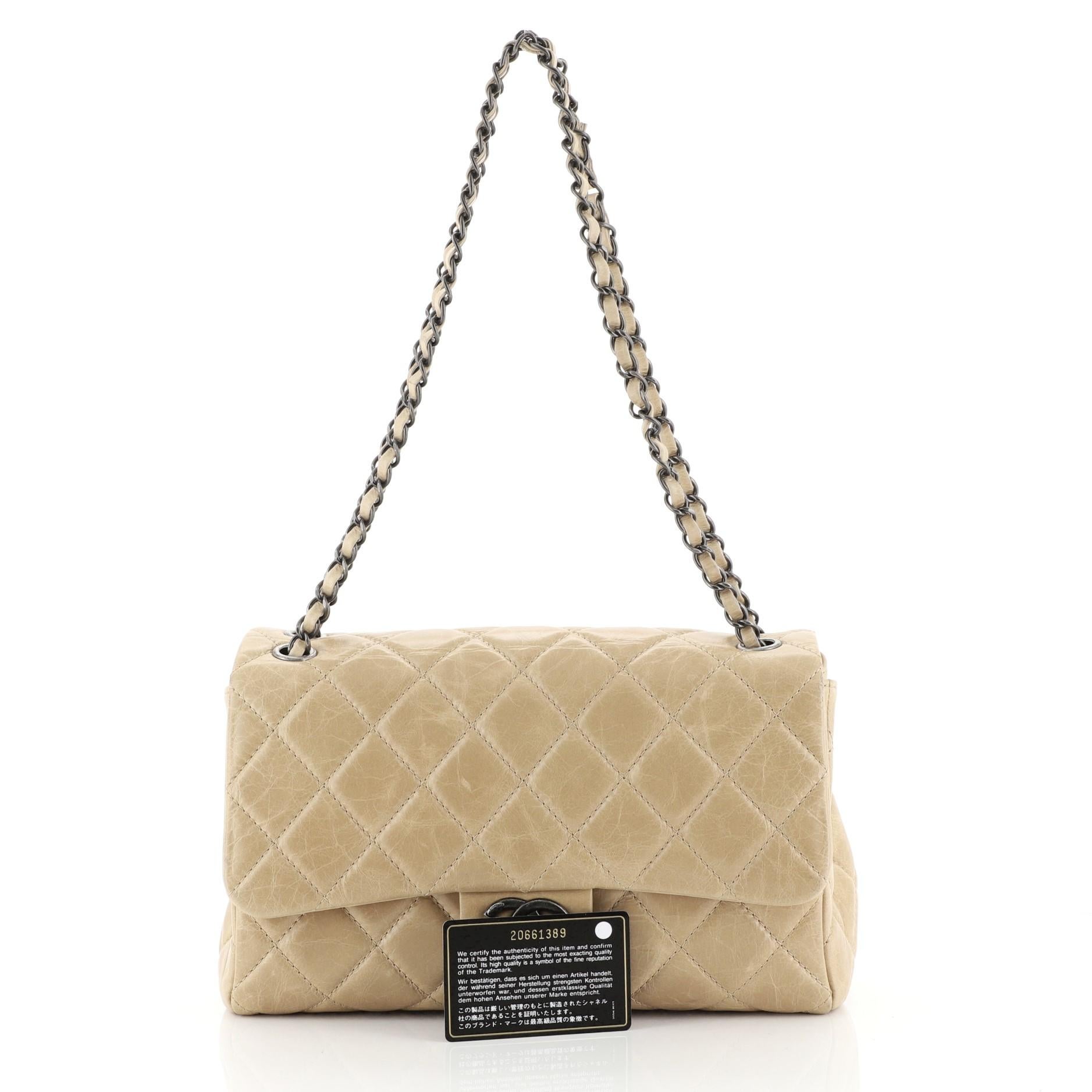 This Chanel Coco Soft Flap Bag Quilted Glazed Calfskin Jumbo, crafted in brown glazed quilted calfskin leather, features woven-in leather chain strap and aged silver-tone hardware. Its CC turn-lock closure opens to a neutral fabric interior with a