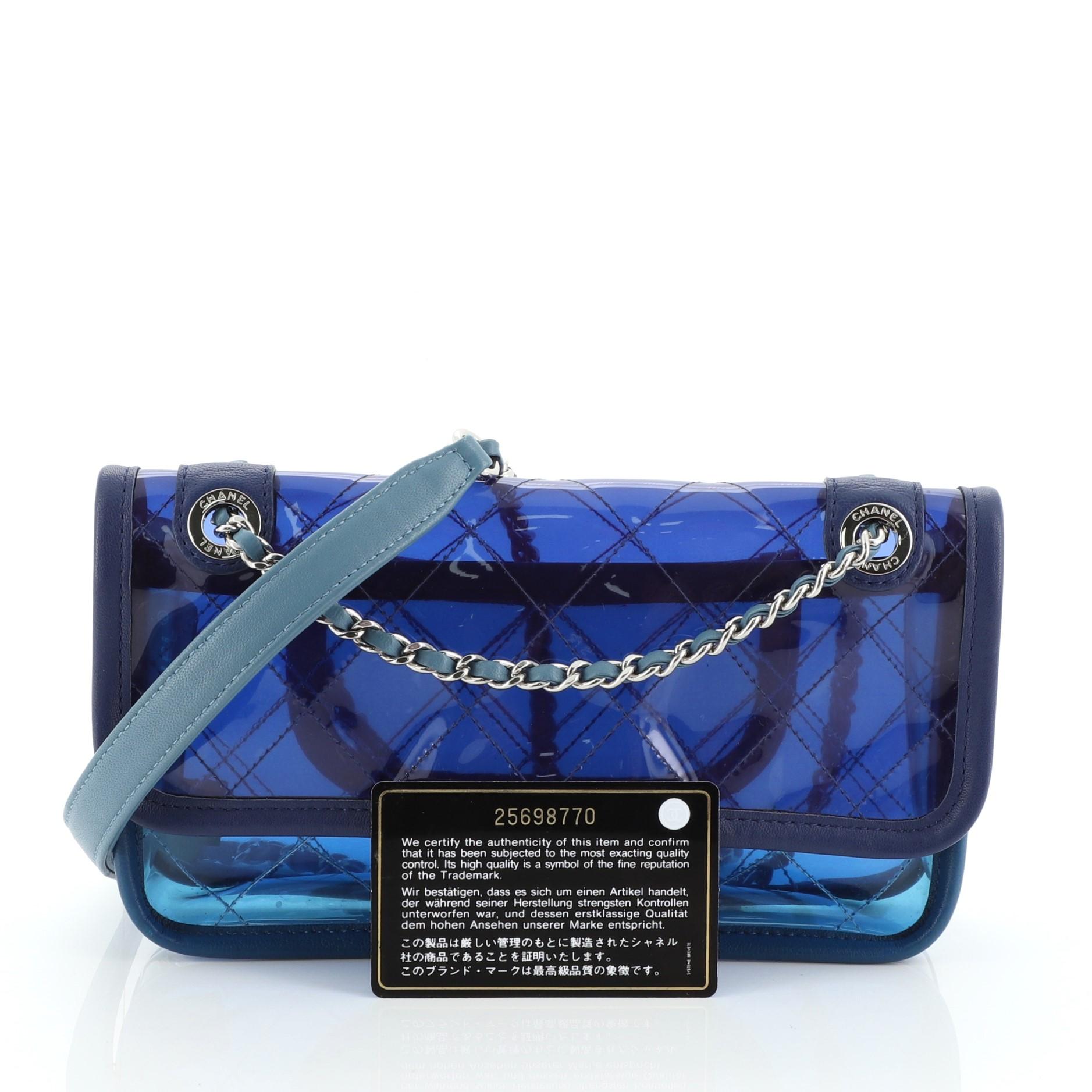 This Chanel Coco Splash Flap Bag Quilted PVC With Lambskin Small, crafted from blue and purple quilted PVC with lambskin leather trim, features woven-in leather chain strap with leather pad, exterior back slip pocket, and silver-tone hardware. Its