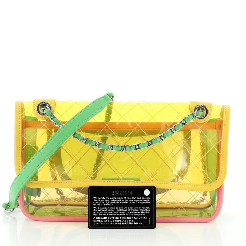 This Chanel Coco Splash Flap Bag Quilted PVC With Lambskin Medium, crafted from green, multicolor, pink, yellow quilted PVC with lambskin leather, features woven-in leather chain strap with leather pad, leather trim, exterior back slip pocket, and