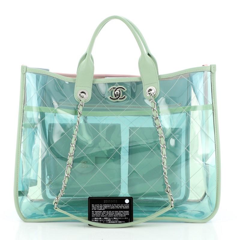 This Chanel Coco Splash Shopping Tote Quilted PVC With Lambskin Medium, crafted in green quilted PVC with lambskin leather trims, features dual woven-in leather chain straps with leather shoulder pads, dual-rolled leather handles, Chanel CC turn