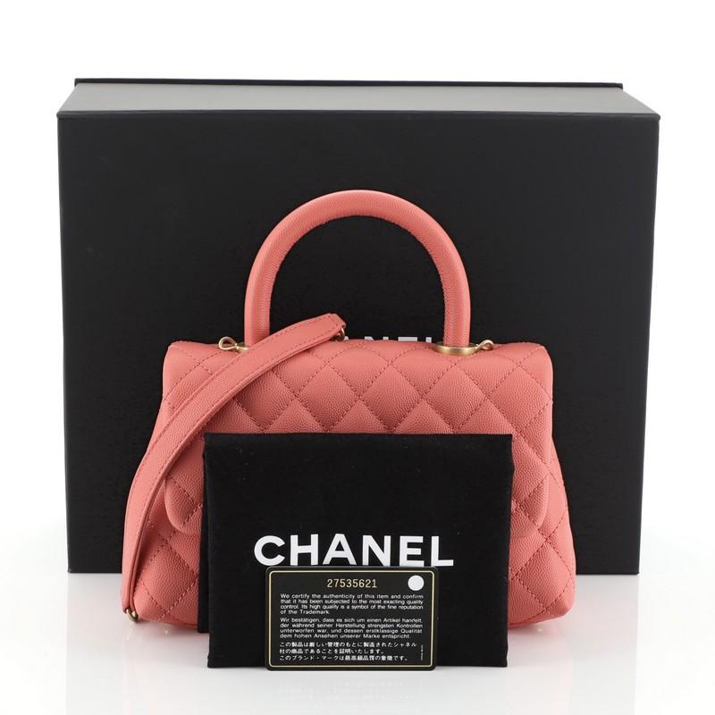 This Chanel Coco Top Handle Bag Quilted Caviar Mini, crafted in pink quilted caviar leather, features a single loop leather handle and gold-tone hardware. Its CC turn-lock closure opens to pink fabric interior. Hologram sticker reads: 27535621.