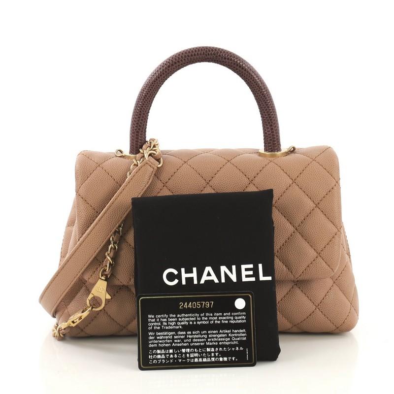 This Chanel Coco Top Handle Bag Quilted Caviar with Lizard Mini, crafted in beige quilted caviar leather with genuine lizard, features a single loop handle and matte gold-tone hardware. Its CC turn-lock closure opens to a beige leather interior with