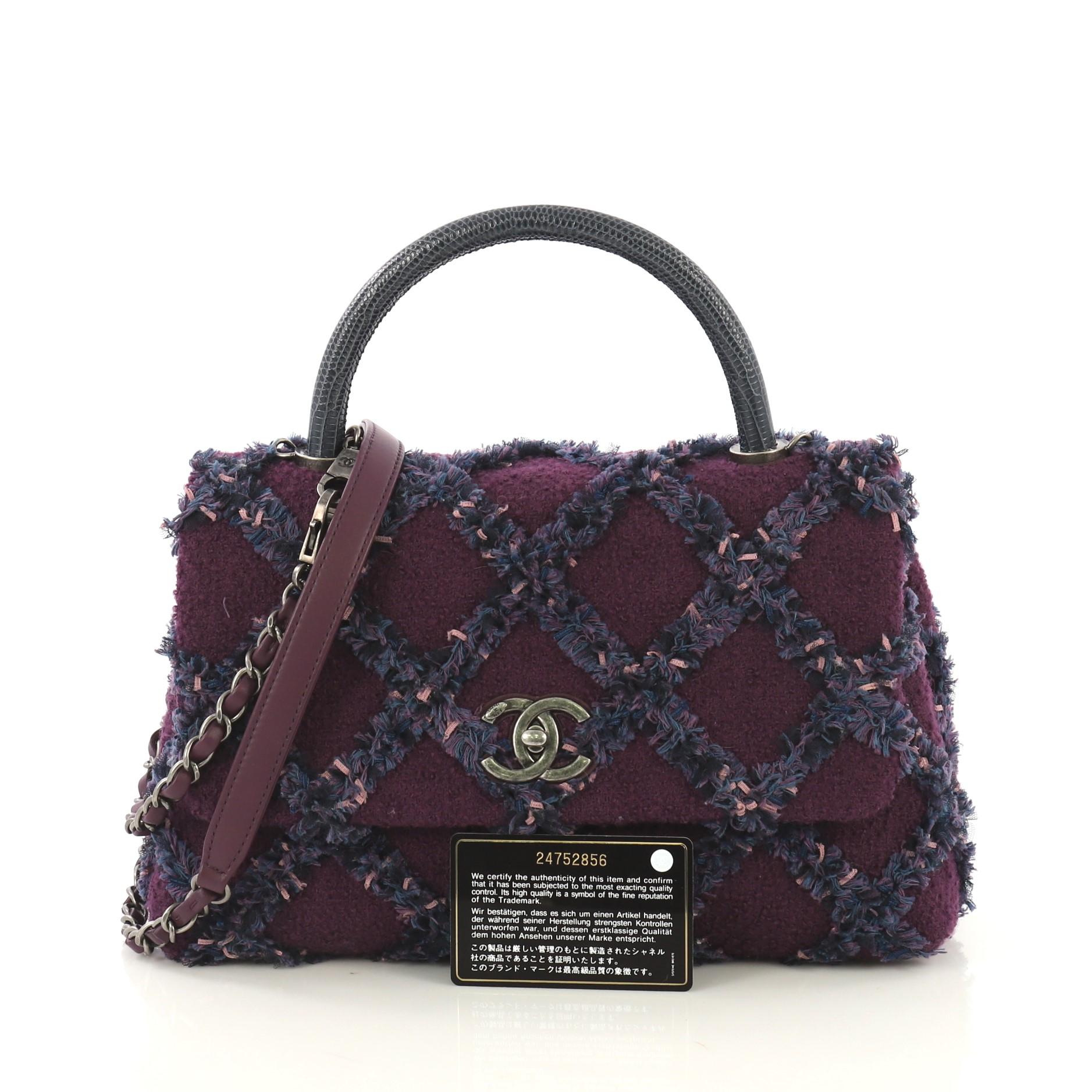 This Chanel Coco Top Handle Bag Quilted Tweed with Lizard Small, crafted in purple quilted tweed, features single rolled top handle in genuine lizard, woven in leather chain link strap with leather pad and aged silver-tone hardware. Its CC turn-lock