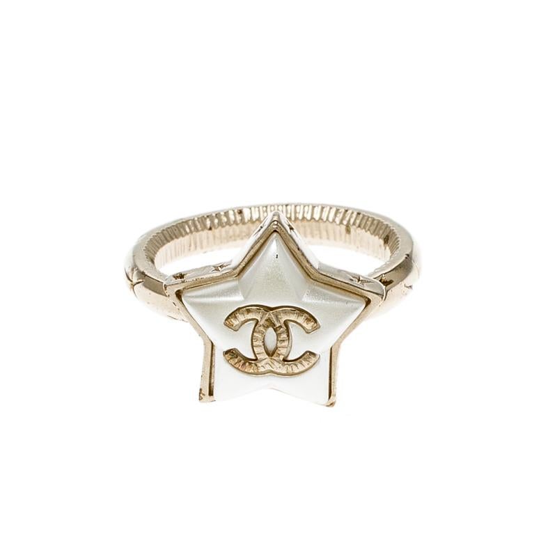 You'll be dreaming of stars every time you slip this gorgeous ring on. This Cocomark Star ring from Chanel is sculpted out of gold-tone metal and the center holds a large star motif set with resin and the iconic CC logo. Shaped to exude simplicity,