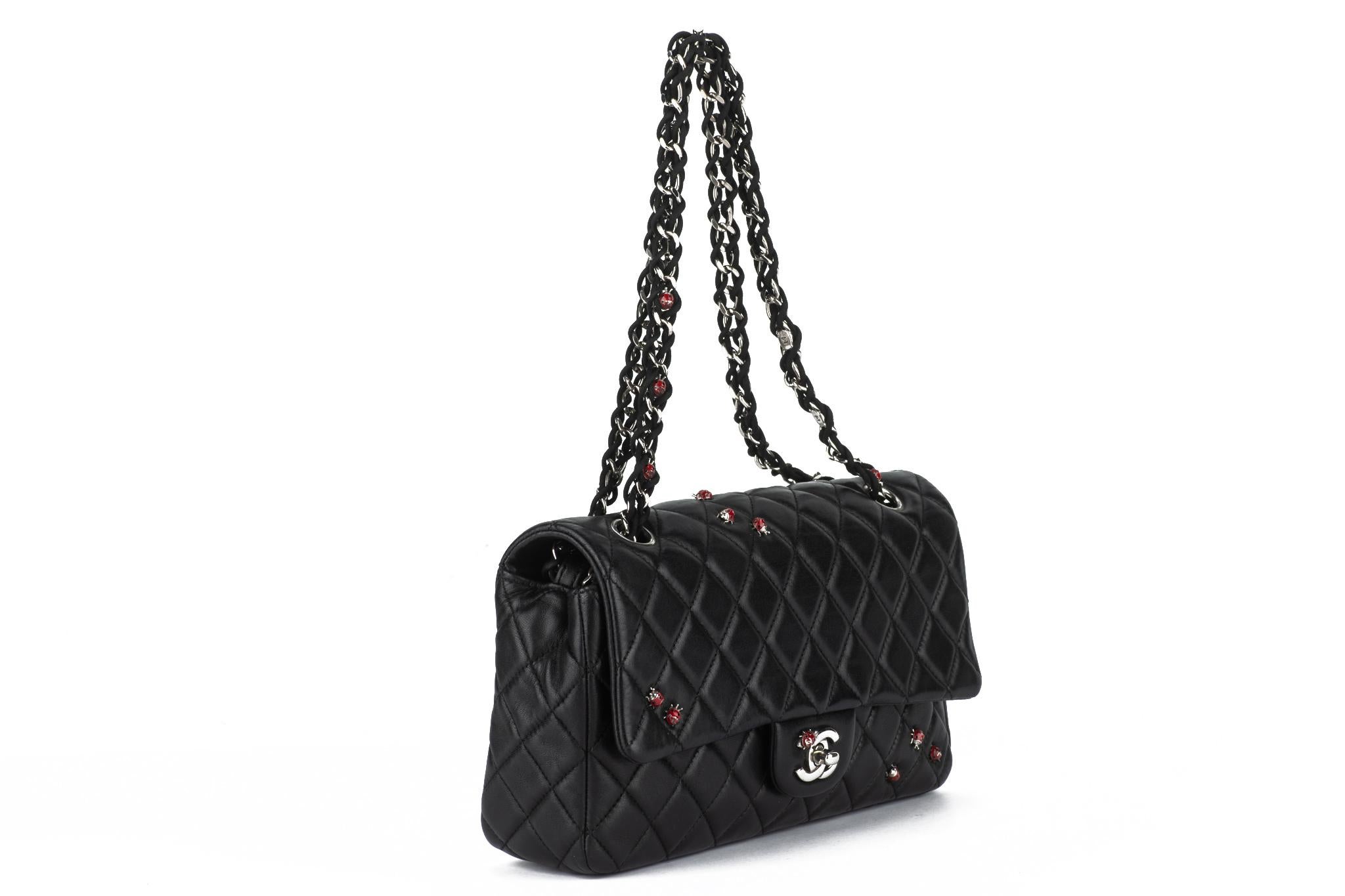 Limited edition lady bug medium flap bag was featured during the 2011Chanel Spring/Summer collection. It features black quilted lambskin and silver hardware. The interior is lined in a tonal textile. Enamelled ladybugs decorate the bag