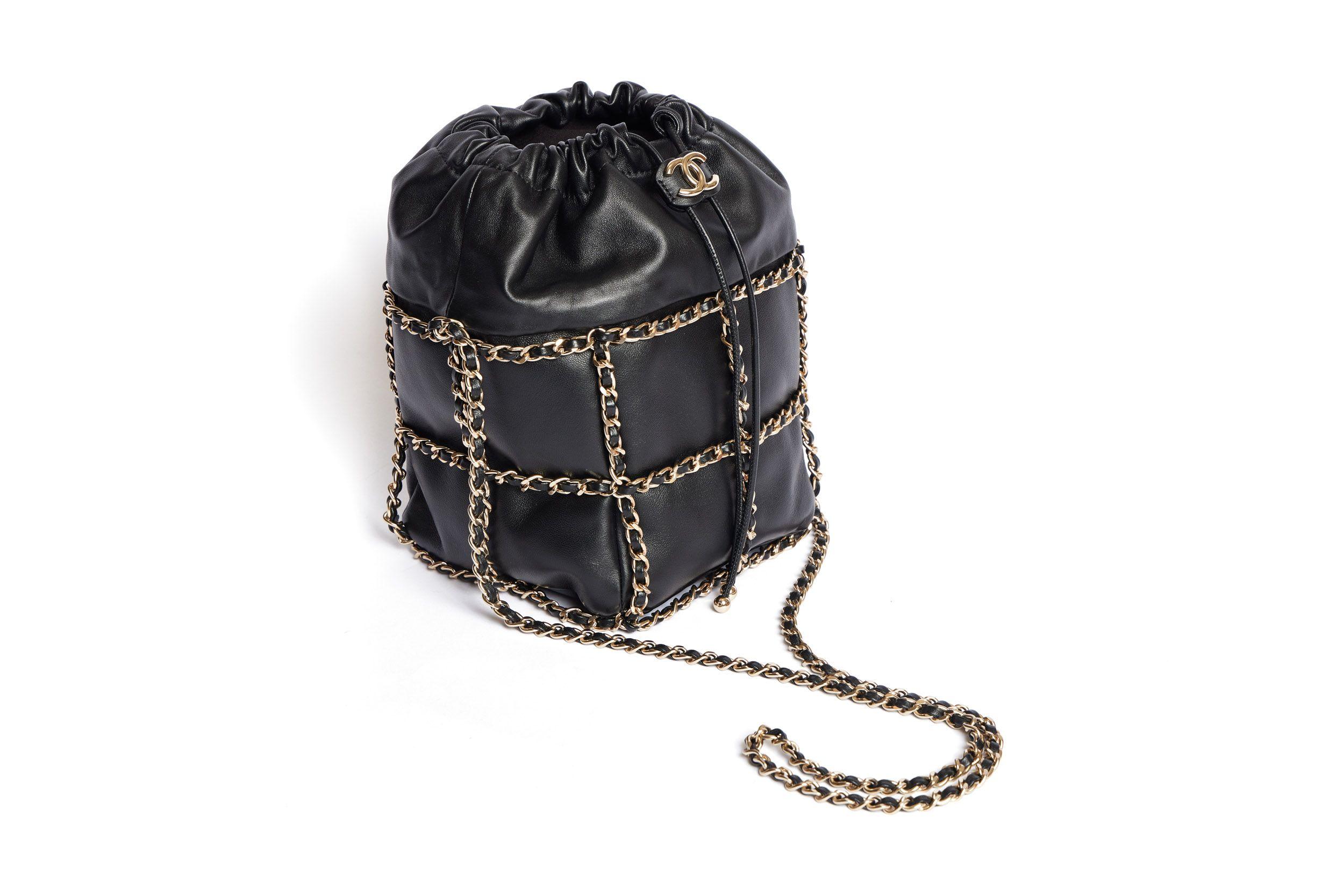 Beautiful Chanel square bucket bag made out of super smooth and soft lambskin. The bag is in a leather-threaded gold chain cage which continues to be the shoulder strap (19’) on top of the bag. The bag closes with a pull strap which has a gold CC