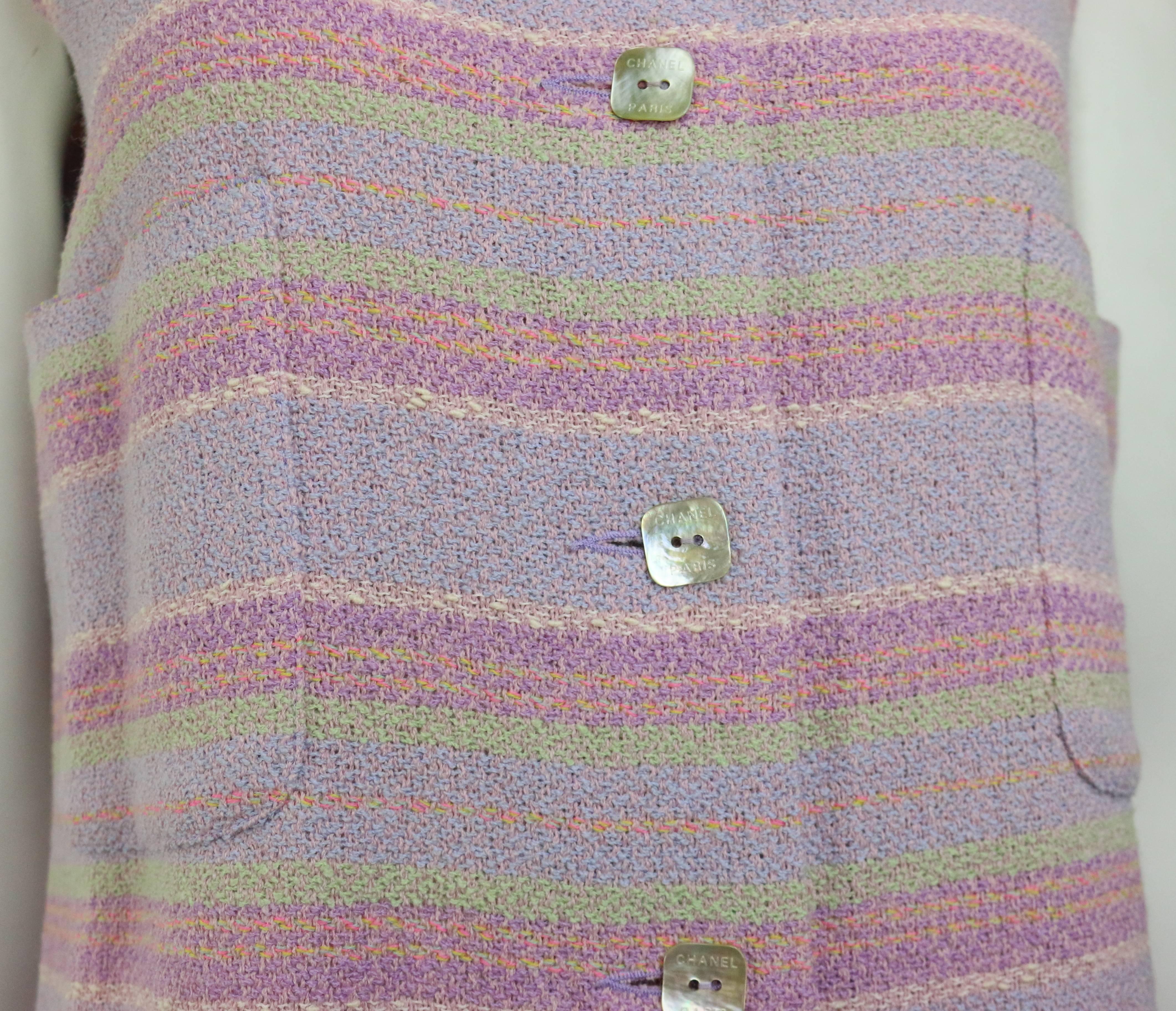 - Chanel multi-coloured wool blend striped tweed dress from 2000 spring/summer collection. 

- Featuring a round neck, a sleeveless, two chest patch pockets and eight front square buttons closure. 

- Wool 81%, Polyamide 19%. 

- Made in France. 

-