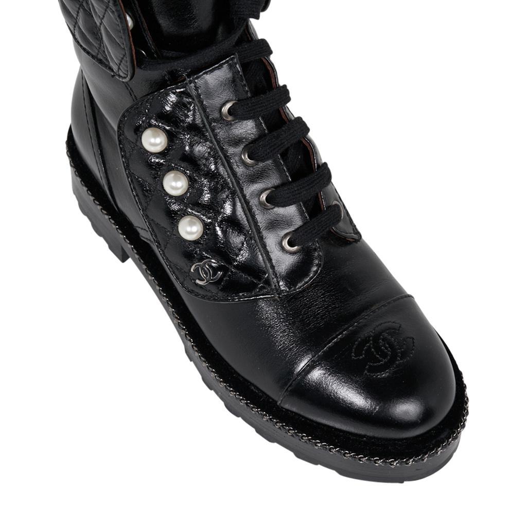 Guaranteed authentic Chanel black 3/4 tall Pearl and Quilted Combat boots. 
From the 2017 Chanel Collection.
Unmistakably Chanel with quilted leather, pearls, signature chain and CC logo on cap toe. 
Edged in Black Velvet above Chain on shoe.
Lug