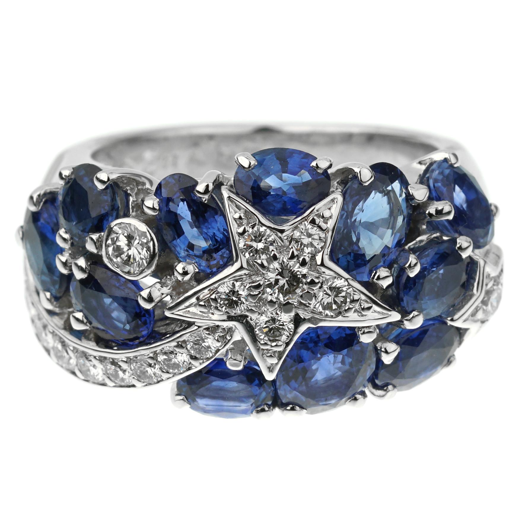 An iconic Chanel cocktail ring from the Comete collection showcasing deep blue sapphires and the iconic stars adorned with round brilliant cut diamonds in 18k white gold. The ring measures a size 5 3/4 and can be resized.