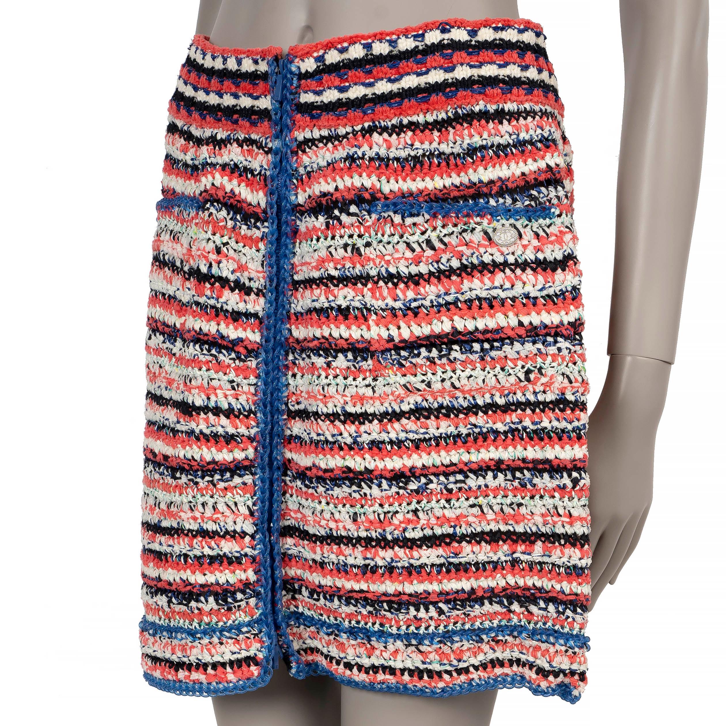 This 100% authentic Chanel knit skirt in coral, blue, black and white striped cotton (54%) and polyamide (46%) offers a vibrant and sophisticated style. It features a straight, cropped silhouette with blue chain trims for detail, a center front and