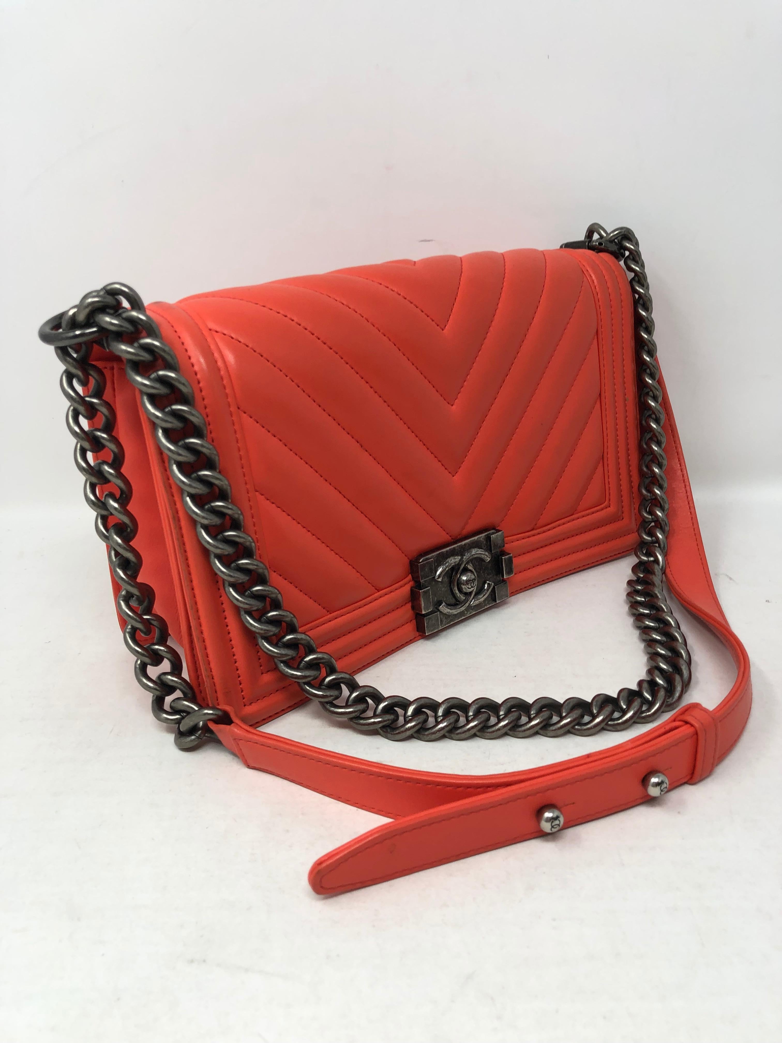Chanel Coral Boy Bag Chevron pattern lambskin leather. Antique silver hardware. Medium size. Can be worn crossbody or doubled as a shoulder bag. Has some wear on the back. Overall fair to good condition. Includes authenticity card and dust cover.