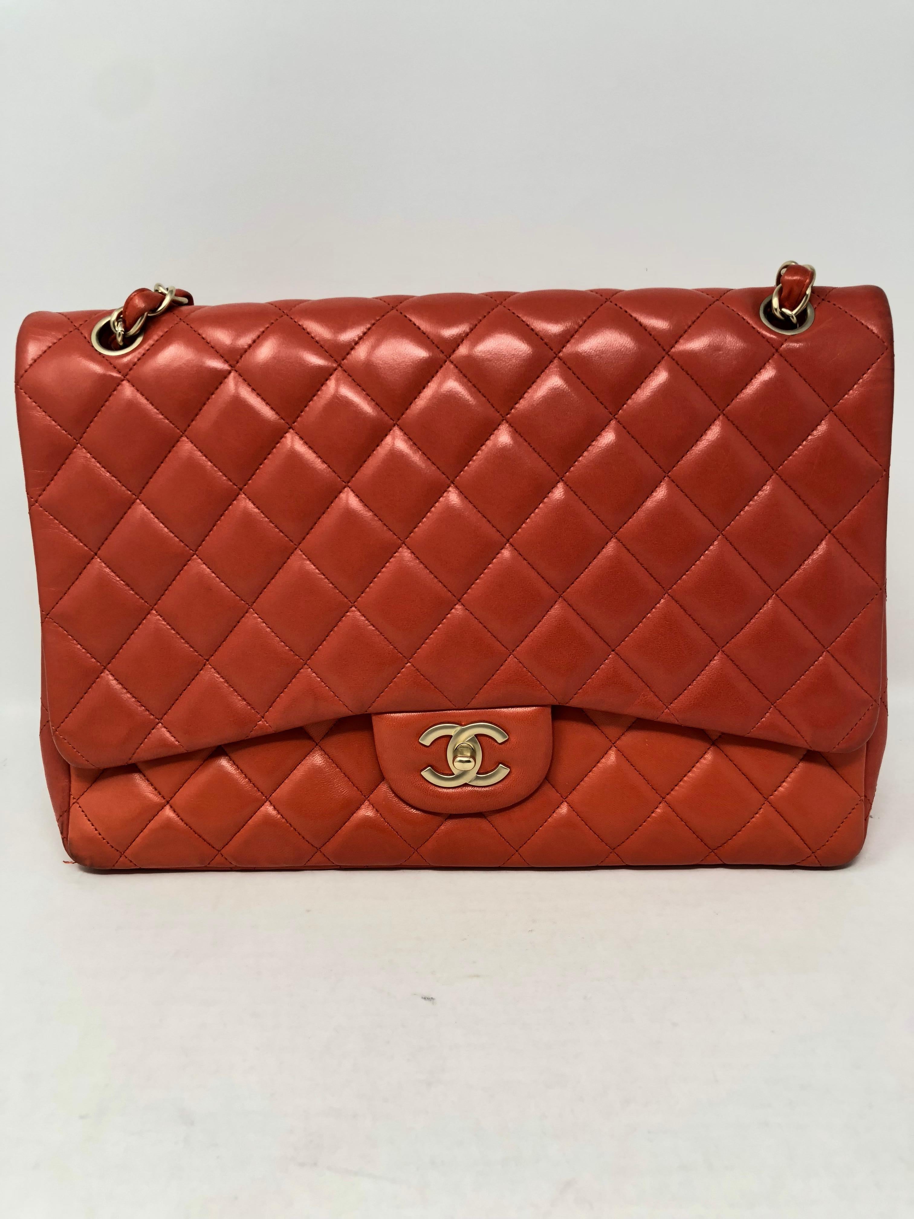 Chanel Coral Maxi Single Flap. Matte gold hardware. Some wear on back. Good condition. Dark coral/ red color. Lambskin leather. Can be worn crossbody as well. Guaranteed authentic. 