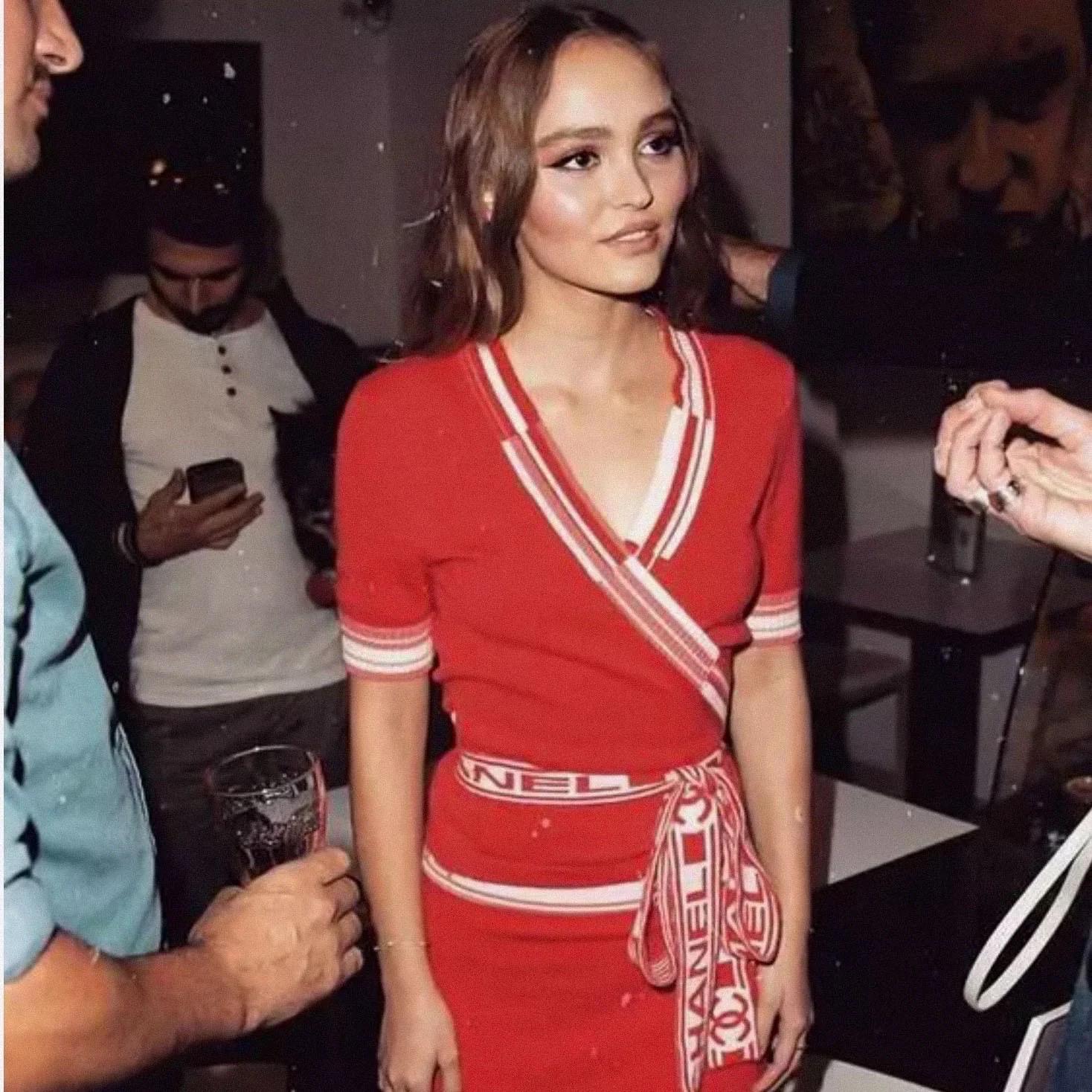 Chanel Coral Pink Cashmere Short Sleeve Wrap Cardigan 

Fall 2013 Ready-to-Wear
Coral Red/Pink/White
Colorblock striping
Intarsia knitting featuring interlocking CC and logo
V-neck, surplice neckline
Front wrap closure with attached self-tie
Made in