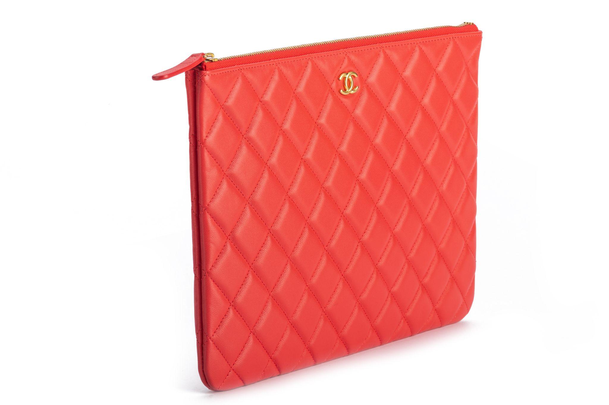 Chanel quilted lambskin coral red clutch with gold tone hardware. New with booklet, hologram, ID card and original dust cover. Collection 27.
