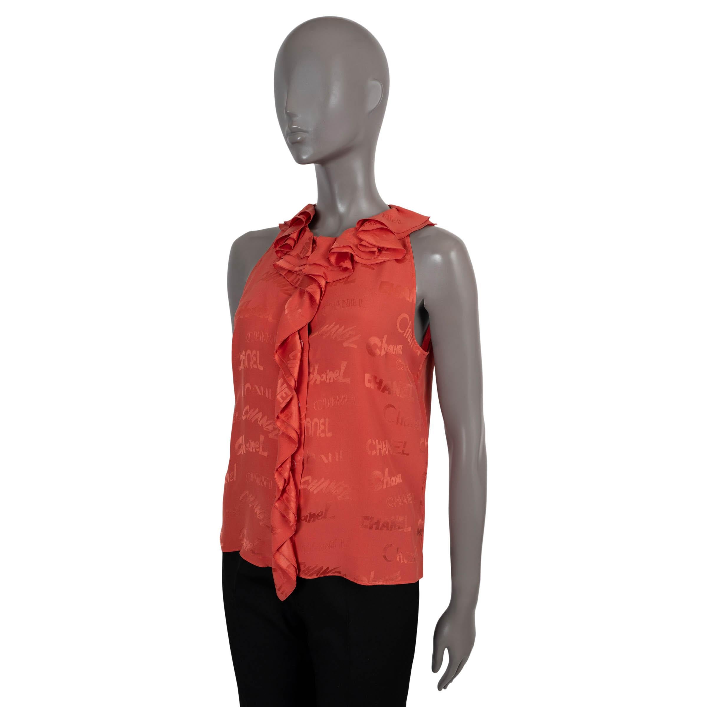 100% authentic Chanel sleeveless blouse in pale coral silk (100%). Featuring an all-over logo print, ruffled neck and trim down the front. Opens with concealed buttons on the front. Has been worn and is in excellent condition. 

2022
