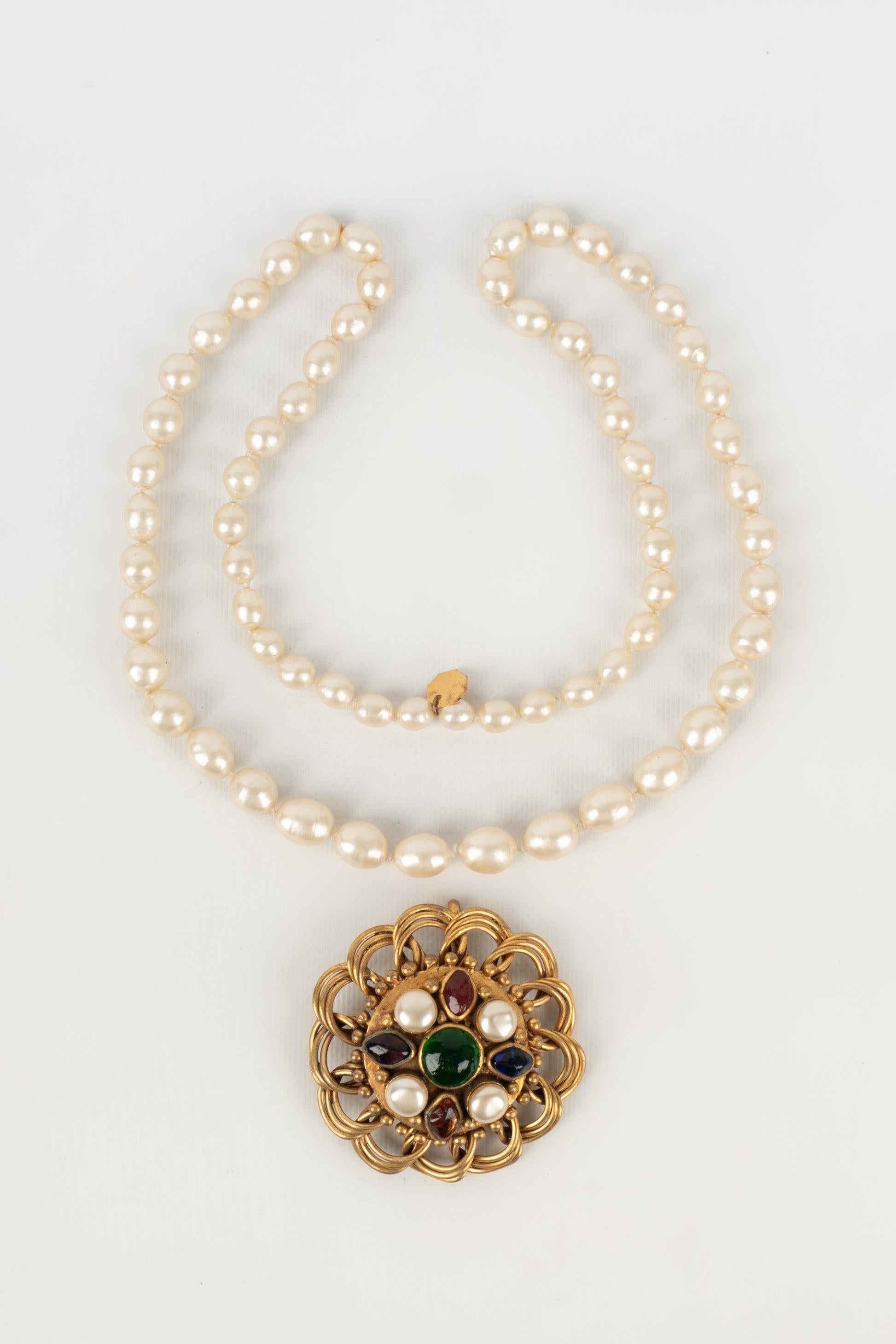 Women's Chanel Costume Pearl Necklace with a Golden Metal Pendant For Sale