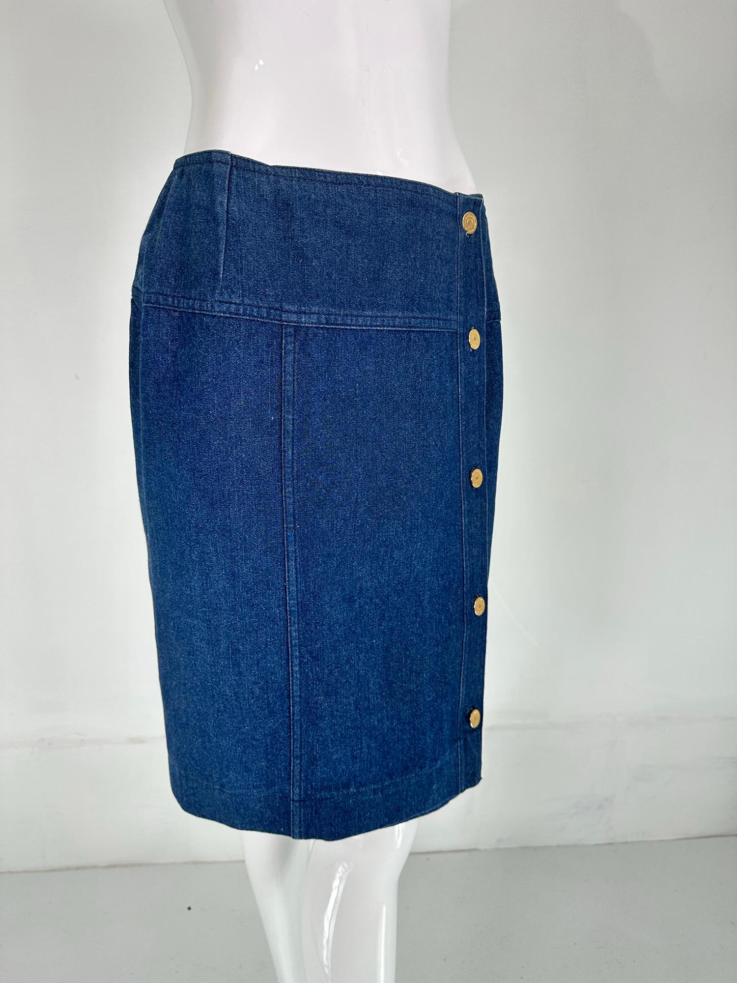 Chanel cotton denim yoke hip, side gold logo button skirt. Wrap skirt closes at the side front with gold Chanel logo buttons, the skirt closes at the waist with hidden hook & eyes at the button side and at the opposite waist side. Unlined. Denim has