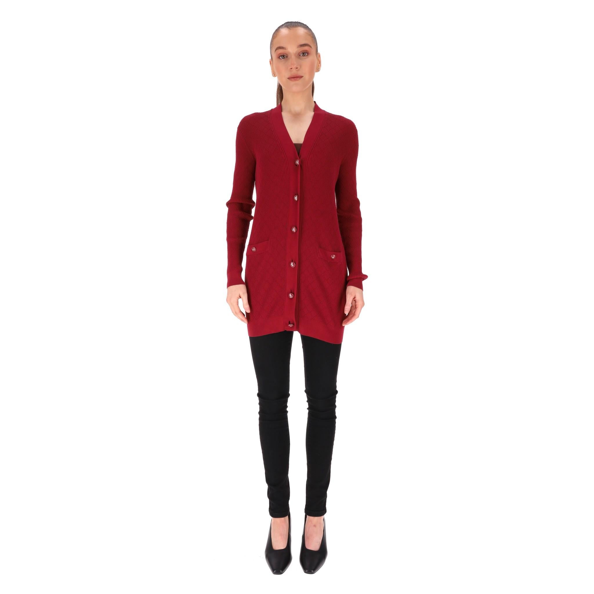 Chanel Cotton Diamond Ribbed Cardigan With 'CC' Logo Buttons

Burgundy cardigan crafted from cotton with diamond knit pattern.

Detailed with red, enamel buttons with silver 'CC' logos.

V-neck, long sleeves and two slip pockets to the front. Rrp