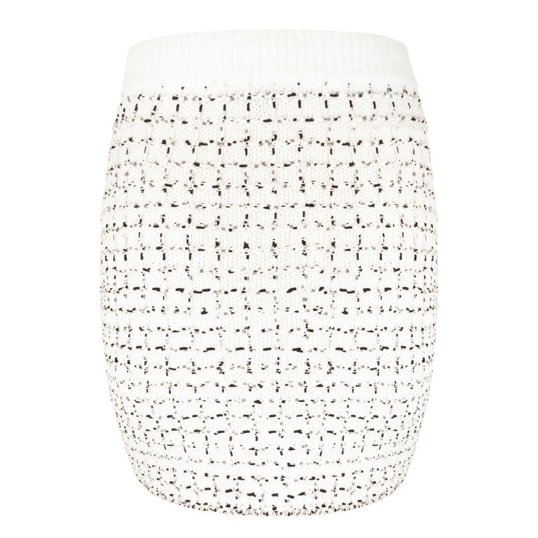 Chanel bright white knit mini sweater skirt with black grid effect pattern. Thick rib knit waistband. Flecks of black and gray throughout. Mini length, approximately mid-thigh depending on height.

Condition Details: Excellent, gently used