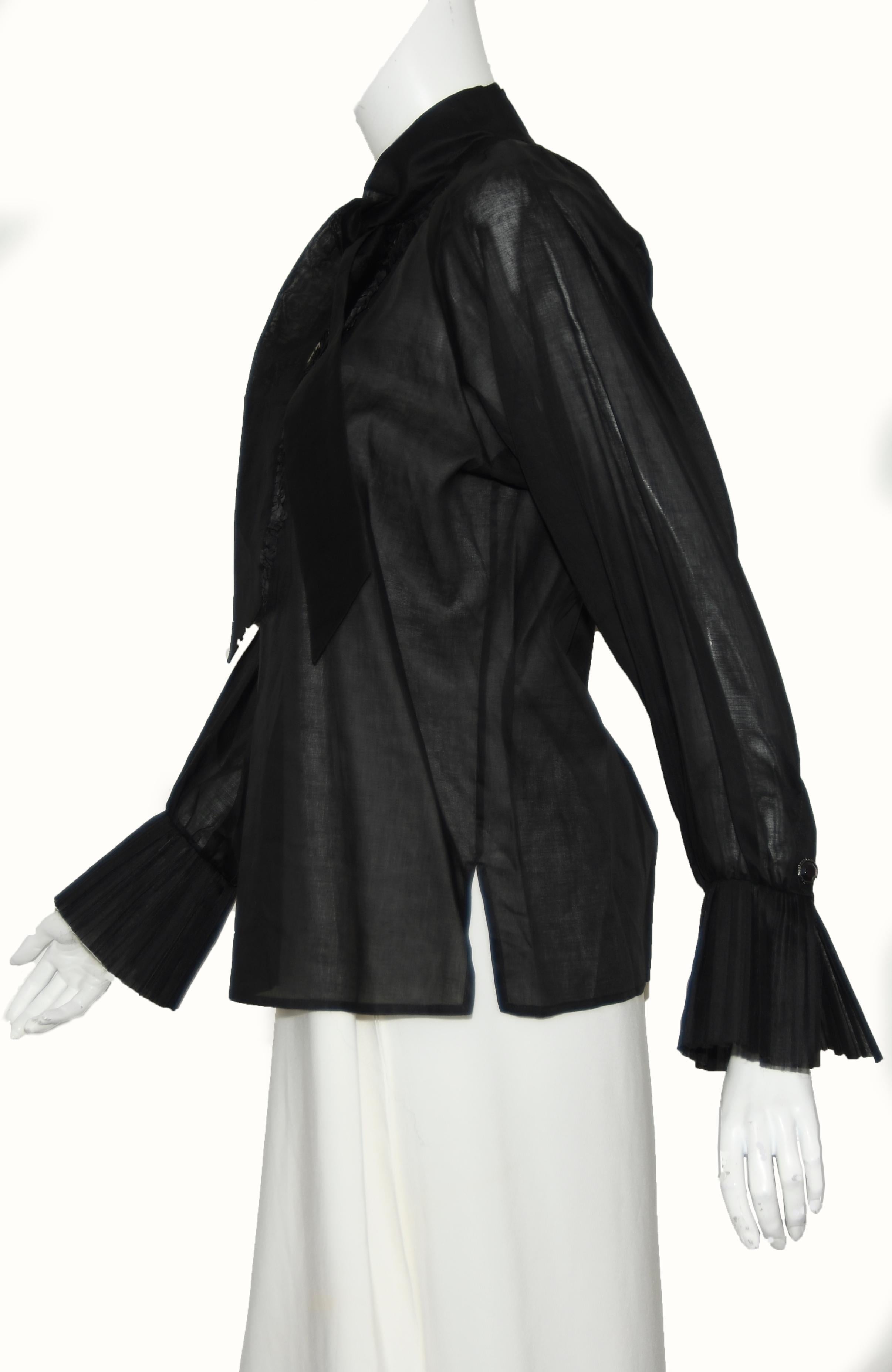 Chanel cotton long sleeve blouse features pleated ruffles on both sides of opening and on the cuffs.   At the collar a sash that can be tied in a bow.   Three Gripoix buttons are found one on each cuff and one just below the opening for decoration. 