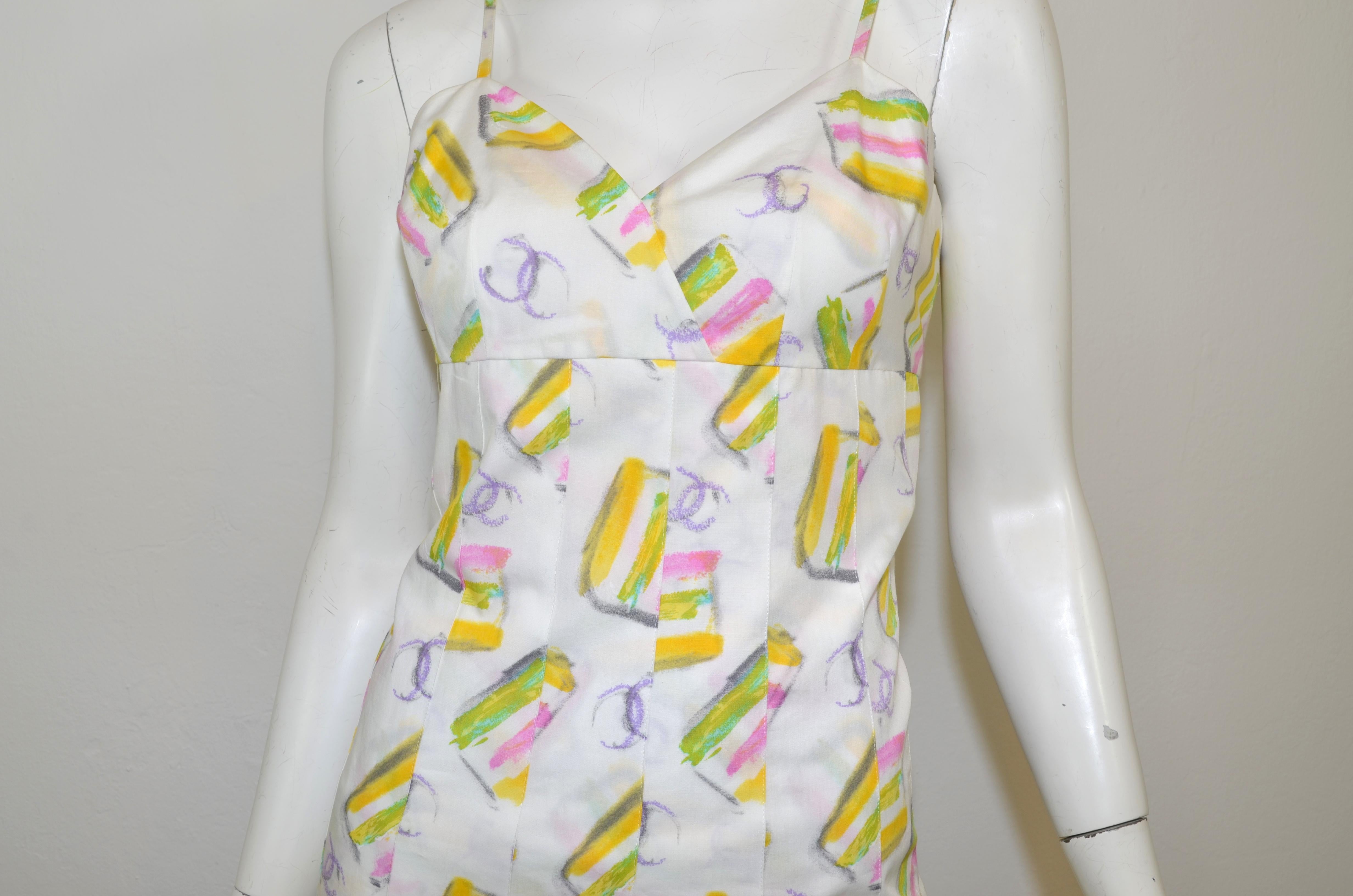 Chanel ice cream print cotton dress from the vintage 2004 Cruise Collection. Dress has spagetti srtaps, a fitted bodice and pleated skirt. Made from 100% cotton. Print is in sorbet pastel colors on a white backgtound with lavender brush stroke CC