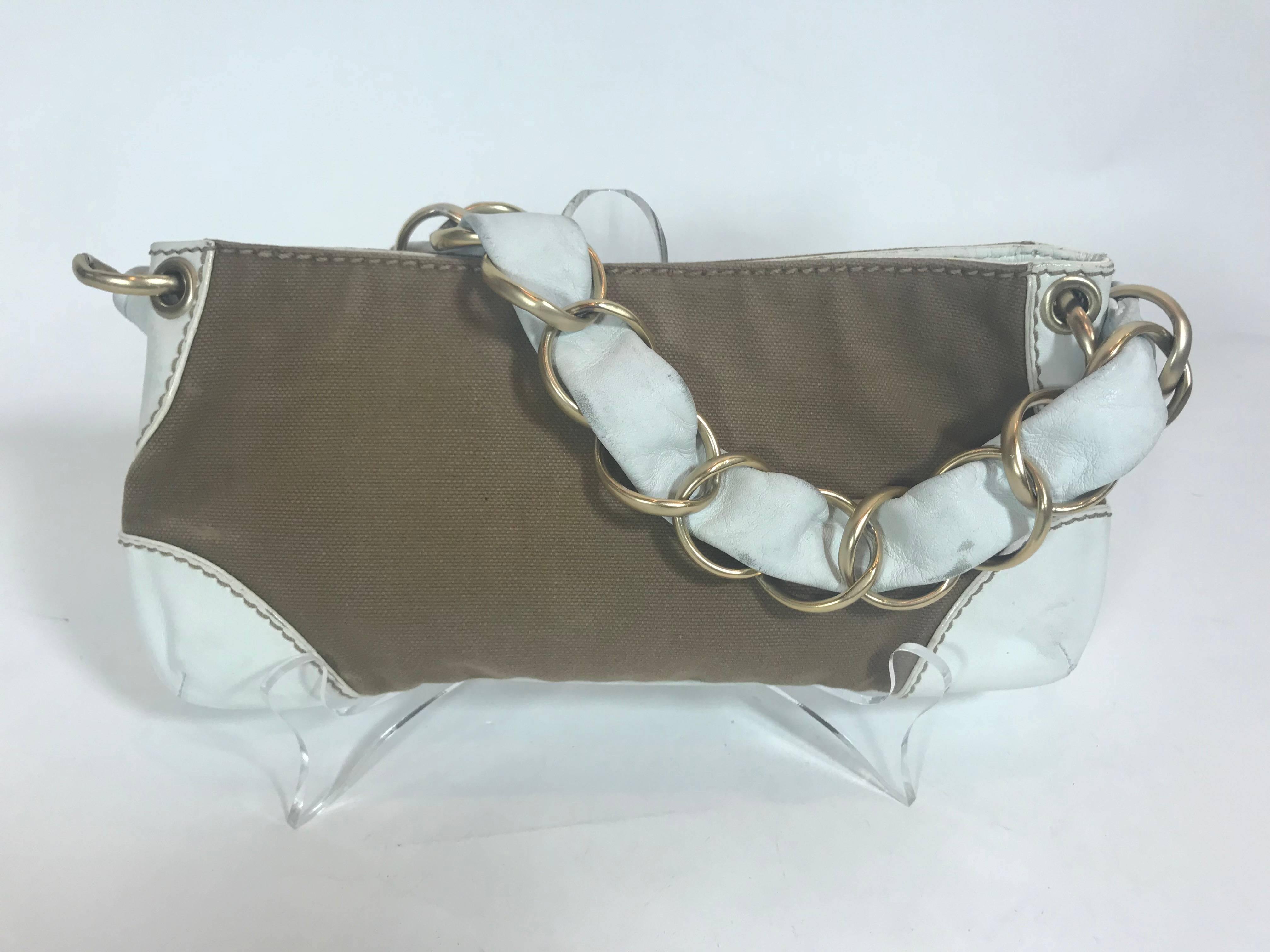 Leather and cotton hand bag
Magnetic closure on top with white leather at edges and strap.
Beige cotton lining interior with 1 side pockets closed with zipper.
Retail: $1,250