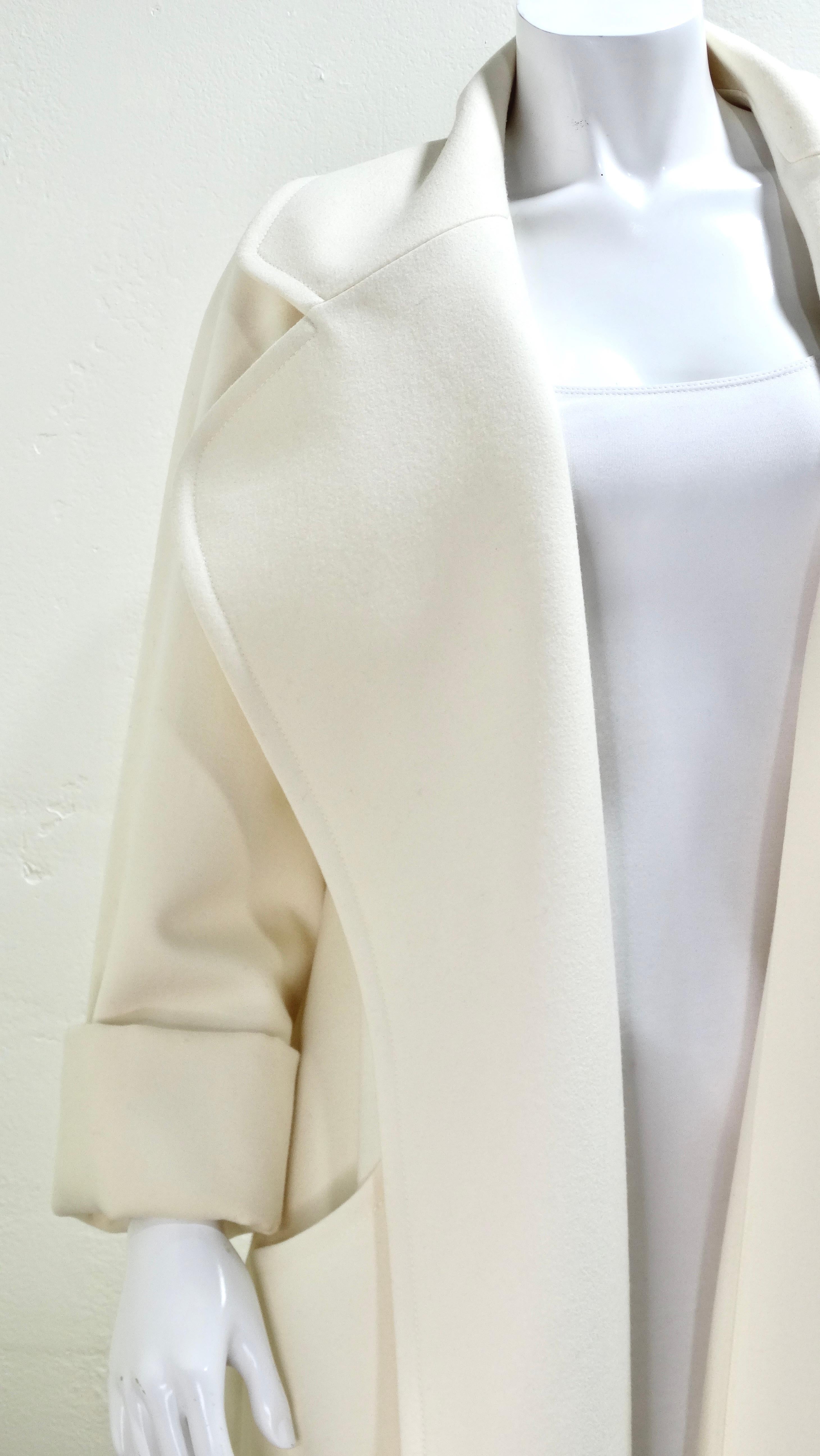 Photos does not do this coat justice! This is a substantial piece of wool and cashmere draped perfectly to create a flowing and elegant coat. It is impeccably tailored to give the most effortless look. This coat is a maxi-length, in an off-white