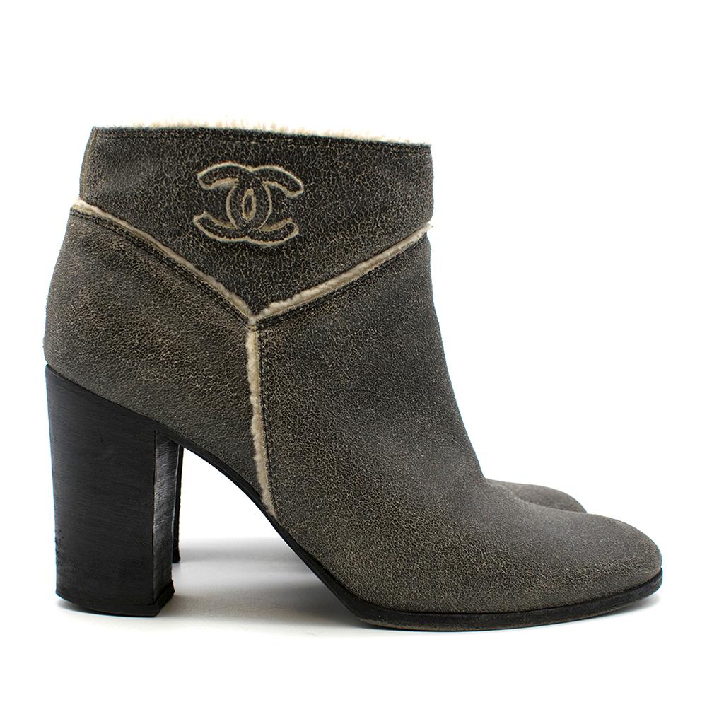 Chanel Crackled Suede Shearling Lined Ankle Boots

- Grey, white, and black suede heeled boots 
- White borg lining 
- CC logo on the sides 
- Black platform heels 

Please note, these items are pre-owned and may show signs of being stored even when