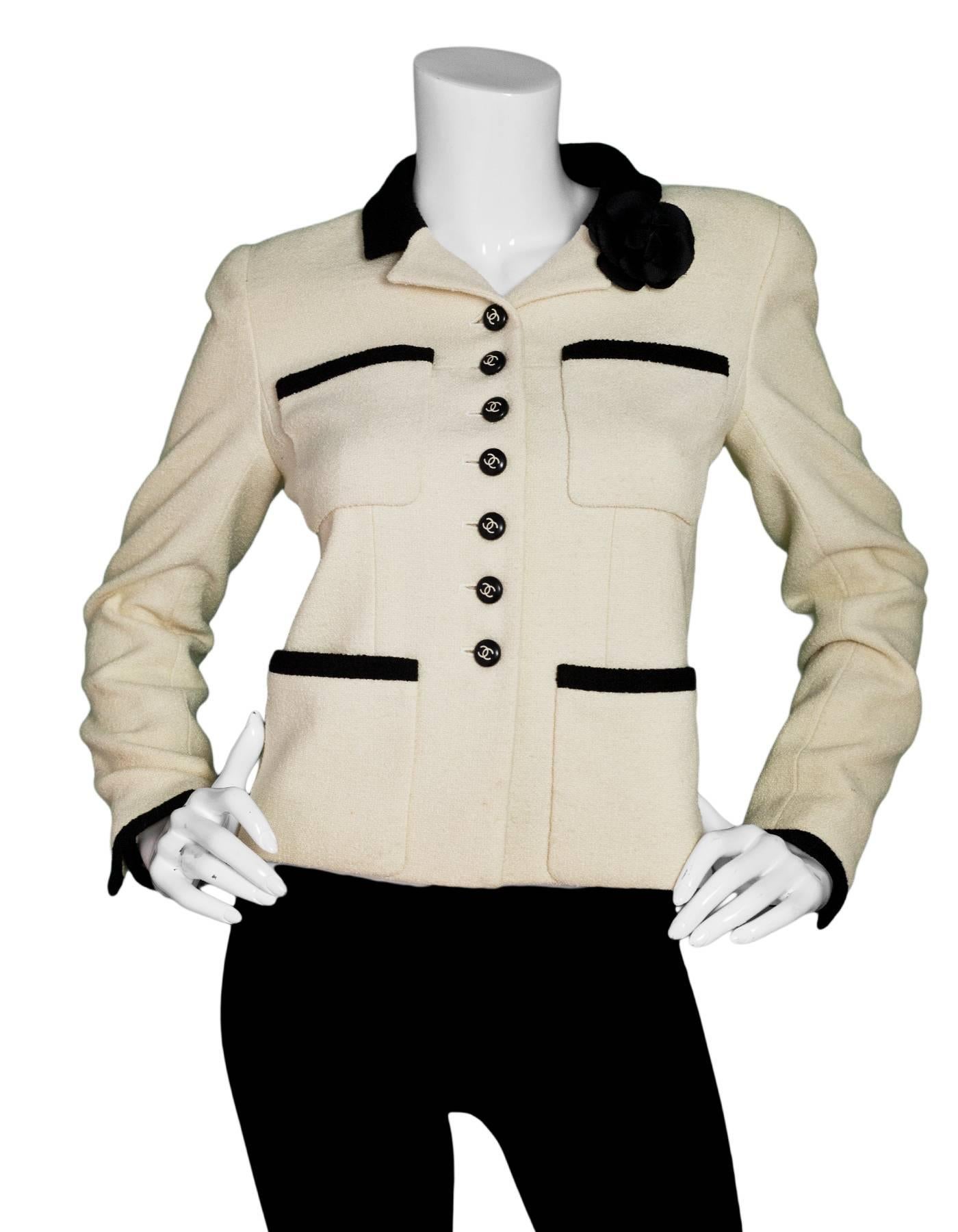 Chanel Cream & Black Jacket 
Features black and white CC buttons and a black camelia pin
**Note: Camelia pin is NOT Chanel**

Made In: France
Color: Cream and black
Composition: 92% wool, 8% nylon
Lining: Beige, 100% silk
Closure/Opening: Button