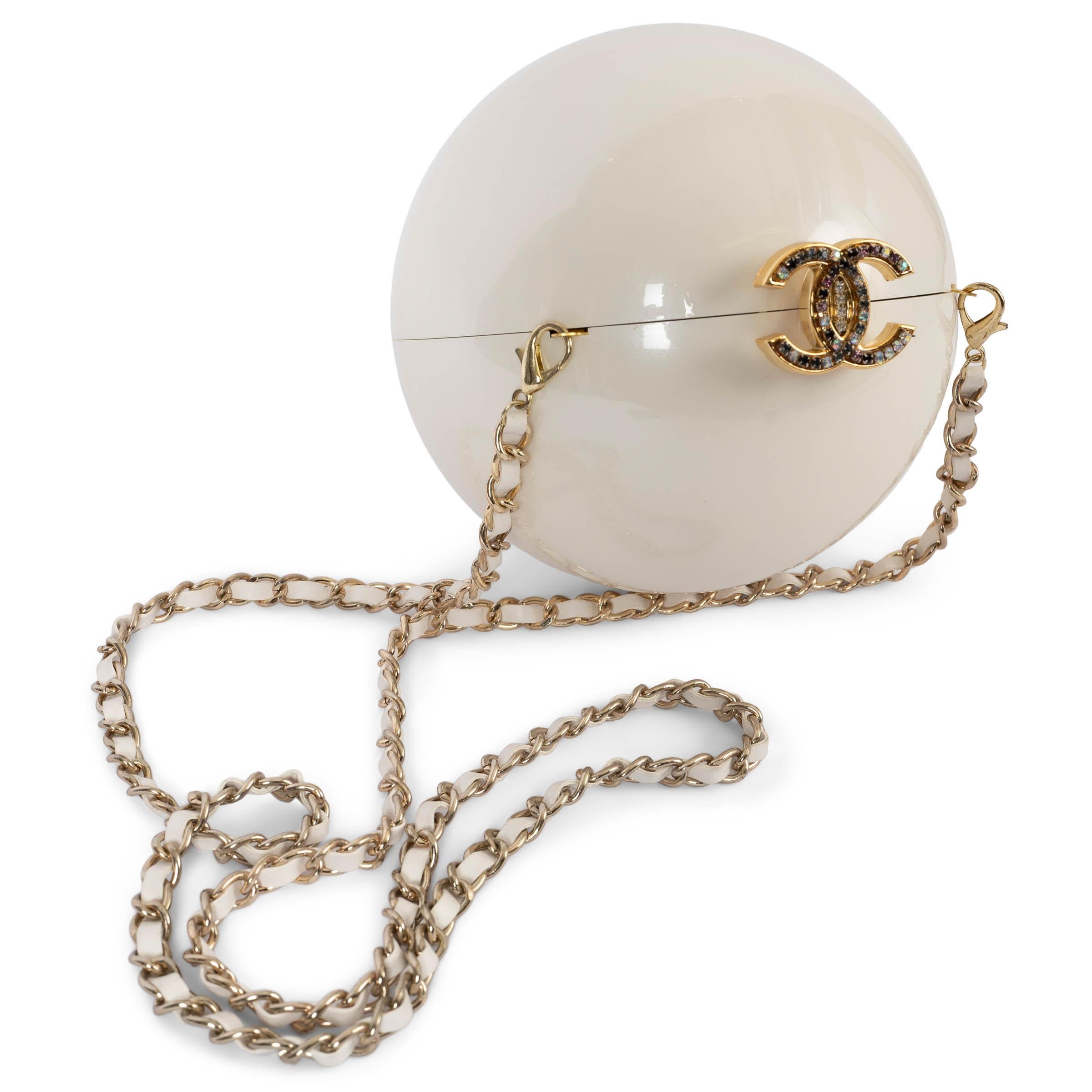 100% authentic Chanel pearl ball in ecru resin with detachable chain shoulder strap and gold-tone hardware, CC crystal embellished push lock top. Lined in black velvet. Has never been carried and comes with original box. 

2016 VIP