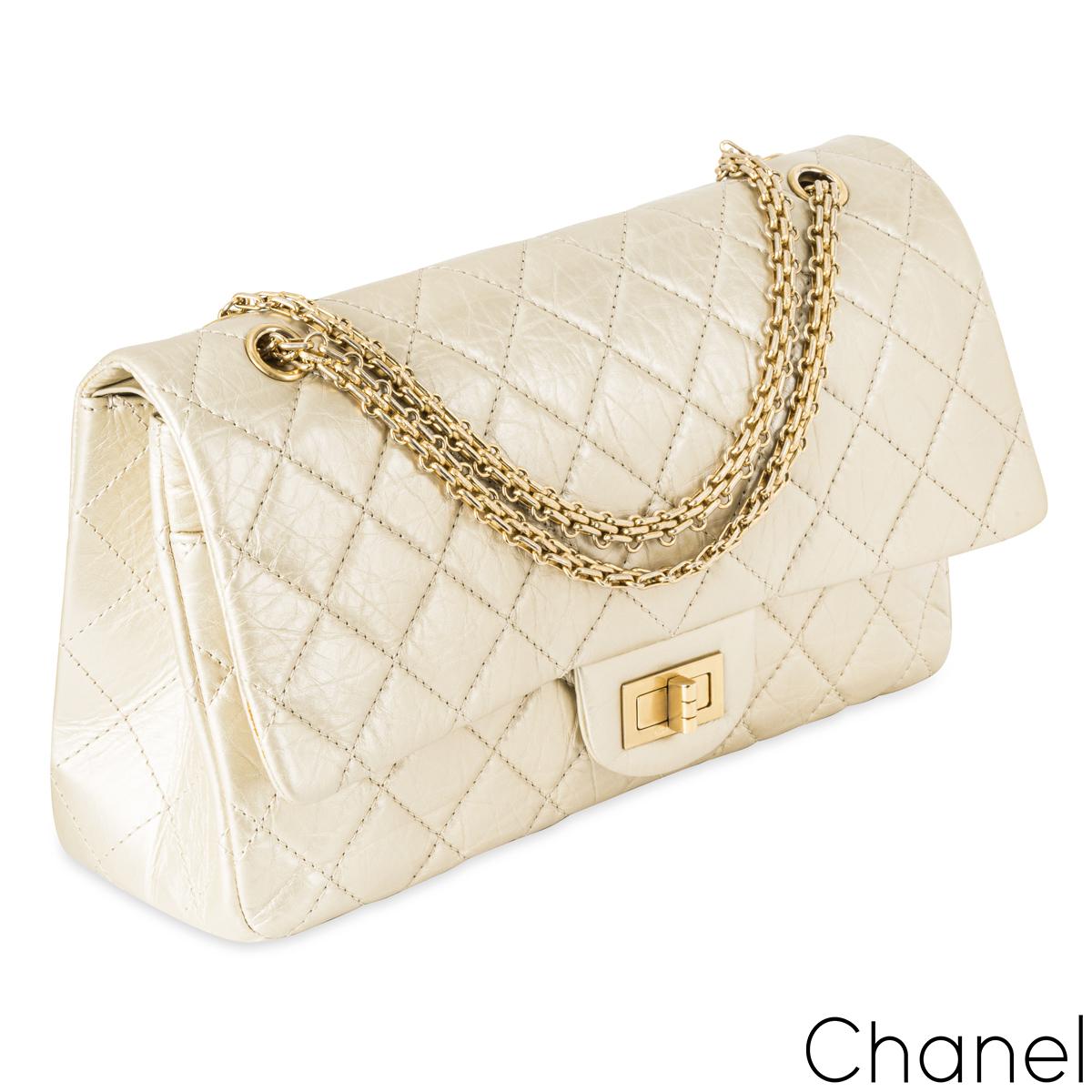 A Chic Chanel 2.55 Reissue Maxi Double Flap Handbag. The exterior of this reissue 2.55 is crafted in metallic cream distressed leather with signature diamond stitching and gold-tone hardware. It features a front flap, a mademoiselle turn lock