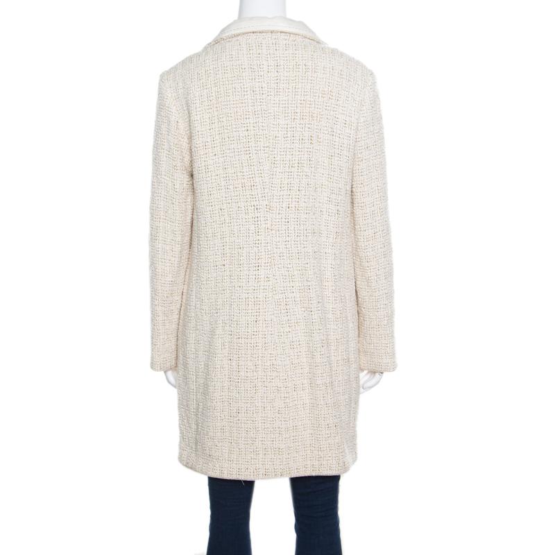 Keep yourself warm and cozy in Chanel's coat. A chic piece that will fabulously complement your evening separates and dresses; this coat flaunts the label's immaculate love for elegance and luxury. It is cut from a silk and mohair blend with silk