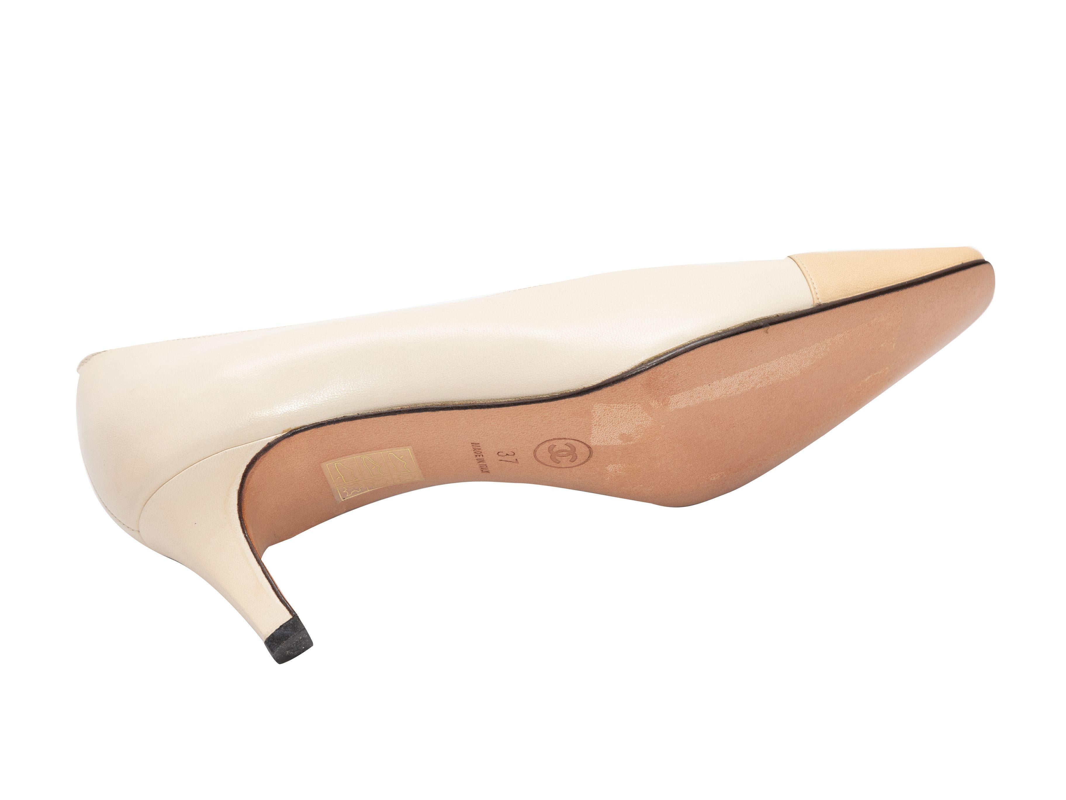 Product Details: Cream and beige cap-toe pumps by Chanel. Kitten heels. 2