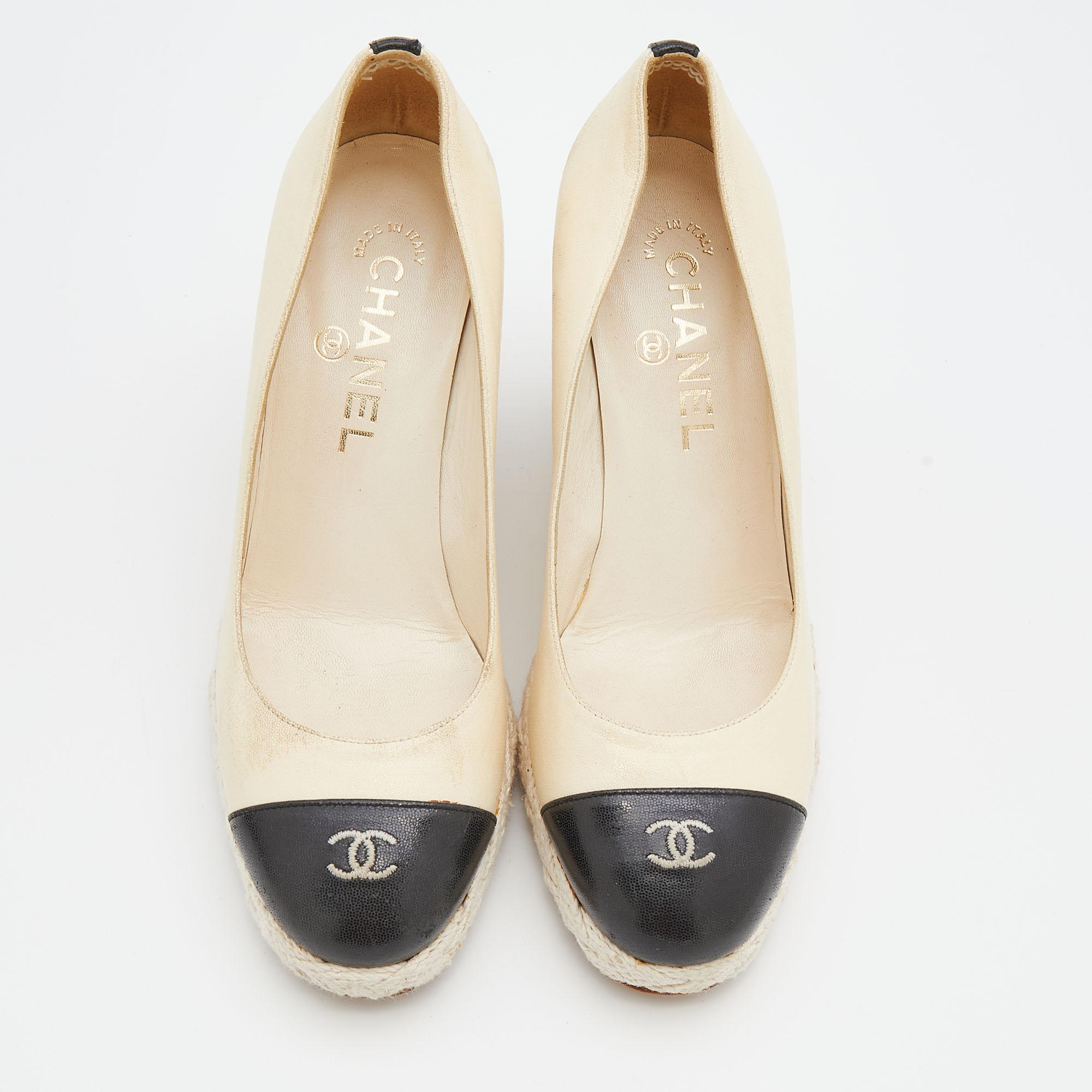Chanel’s elegance and distinctive style are evident in this pair of pumps. Made from leather, it features espadrille trims, platforms and wedge heels. The 'CC' detailing on the cap toes offer these shoes a signature touch.

Includes: Original