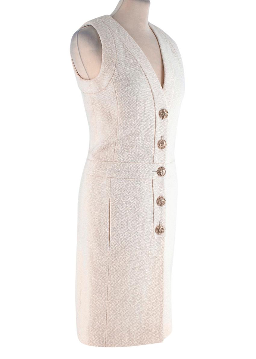 Chanel Cream Boucle Button Front Sleeveless Dress
 

 - Light cream wool boucle sleeveless shift dress, with gentle shaping
 - V-neck neck, button through with embellished faux-crystal flower buttons
 -Silk lining
 - Option to style with a feather