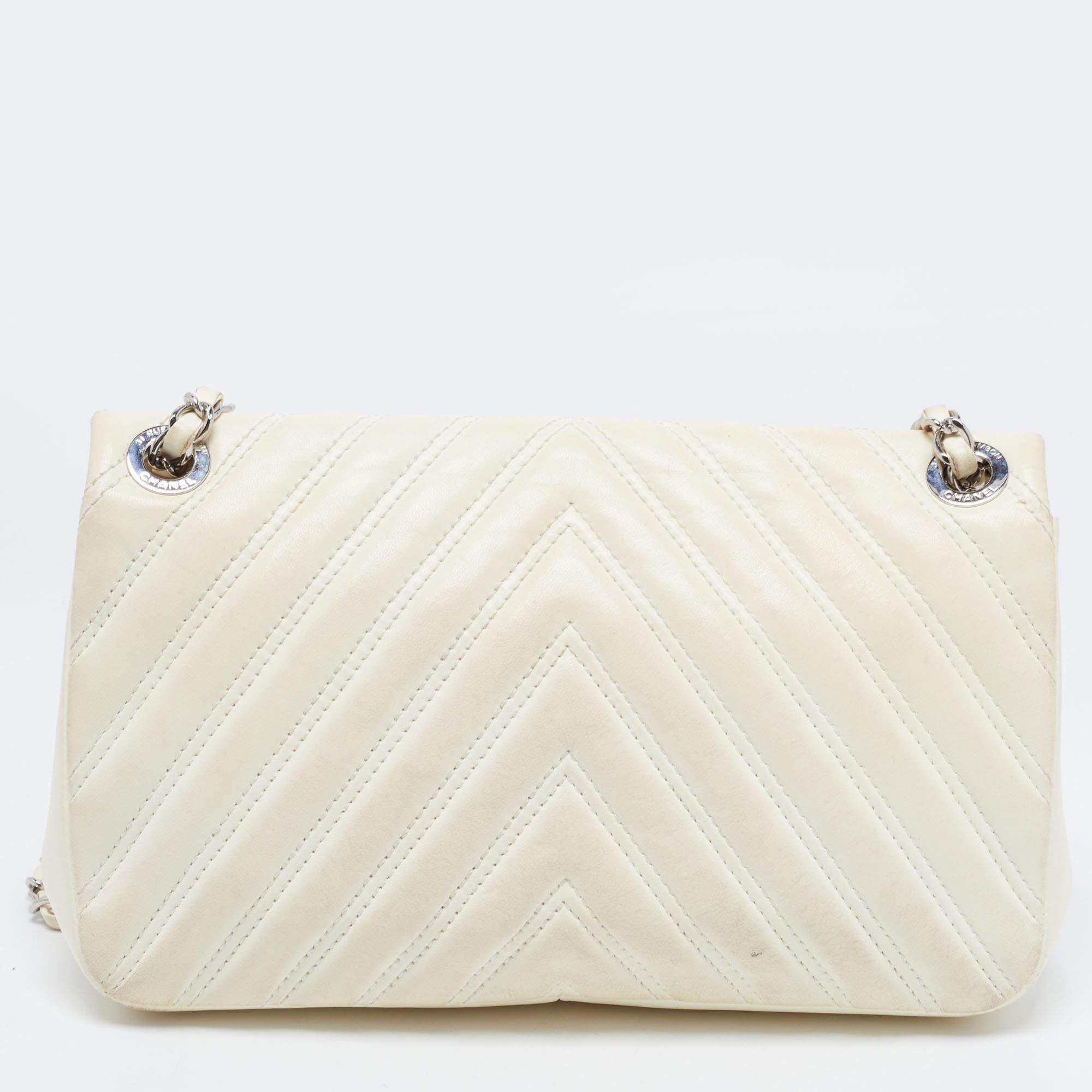 We're bringing Chanel's iconic Classic Flap bag to your closet with this creation. Beautifully crafted from chevron leather, it bears the signature label within the canvas interior and the iconic CC turn-lock on the flap. The piece has silver-tone