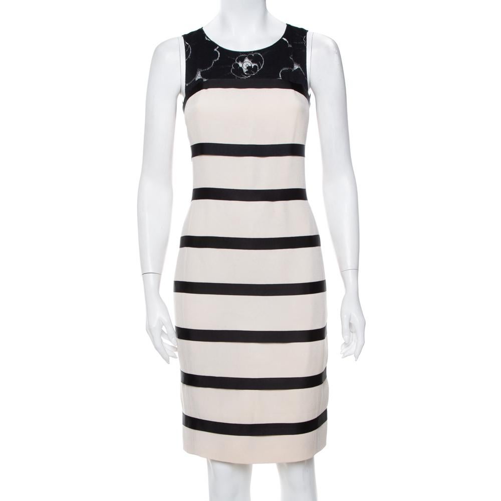 This dress-shrug set is an example of Chanel's expertise in creating classic clothing. Created using quality materials, the Chanel dress set has a sleeveless striped dress and a lace shrug. You can wear them together or separately.


