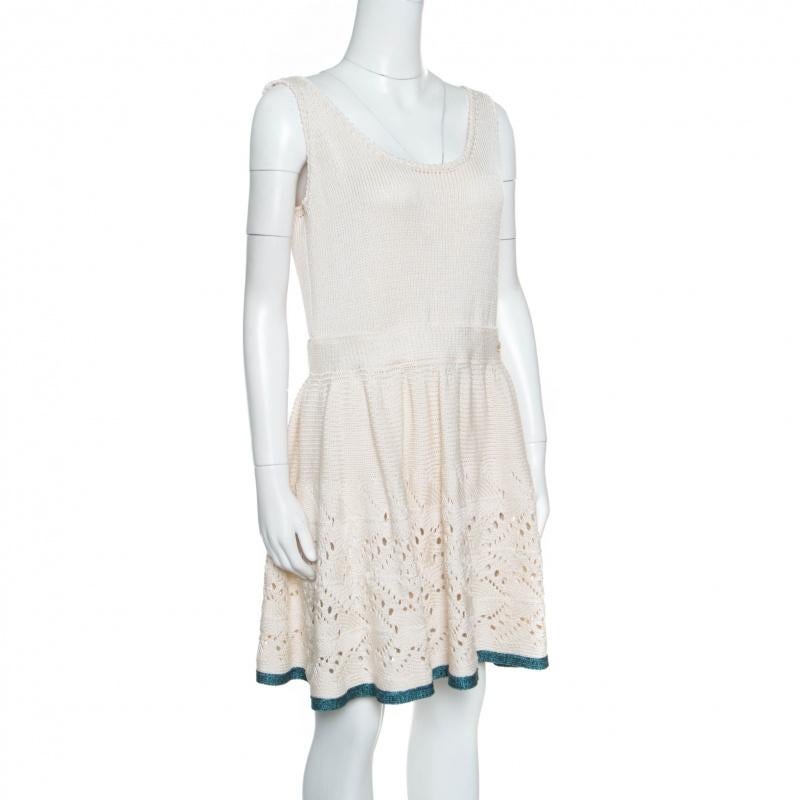 This lovely sleeveless dress from Chanel will look absolutely wonderful on you! The cream creation is made of a cotton and silk blend and features a crochet knit design. It flaunts a flared silhouette below the waist with a contrasting hemline. Pair